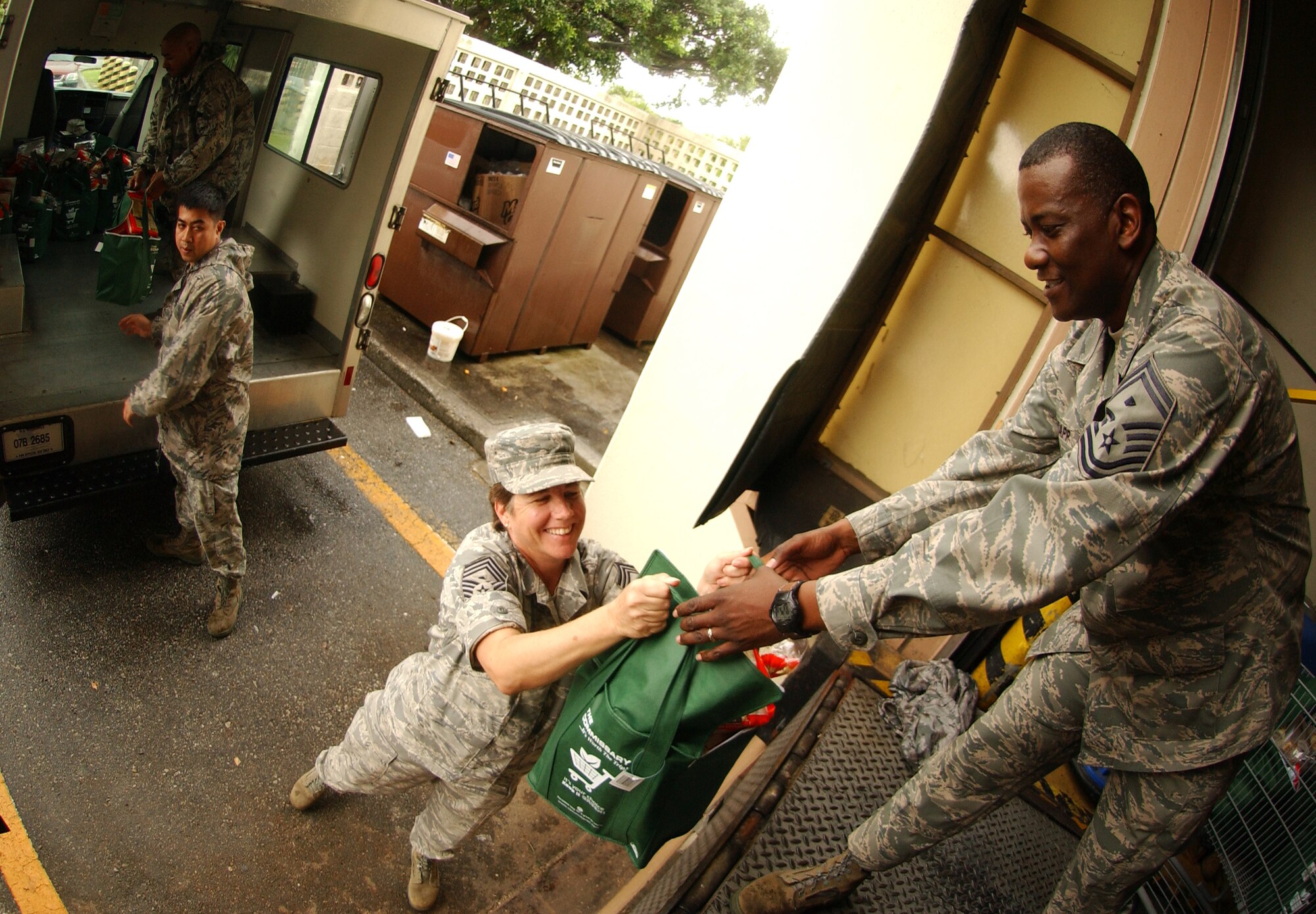 Military members load bags filled with a Thanksgiving turkey and other canned goods on to a truck for delivery to families in need as part of Operation Warmheart at the Kadena Air Base Commissary Nov. 24. Operation Warmheart is a charity designed to help enlisted personnel and their families with loans, grants, and other needs through fundraisers and donations. The 18th Wing Chapel donated more than $8K for this Thanksgiving food drive. (U.S. Air Force photo/Tech. Sgt. Rey Ramon) 