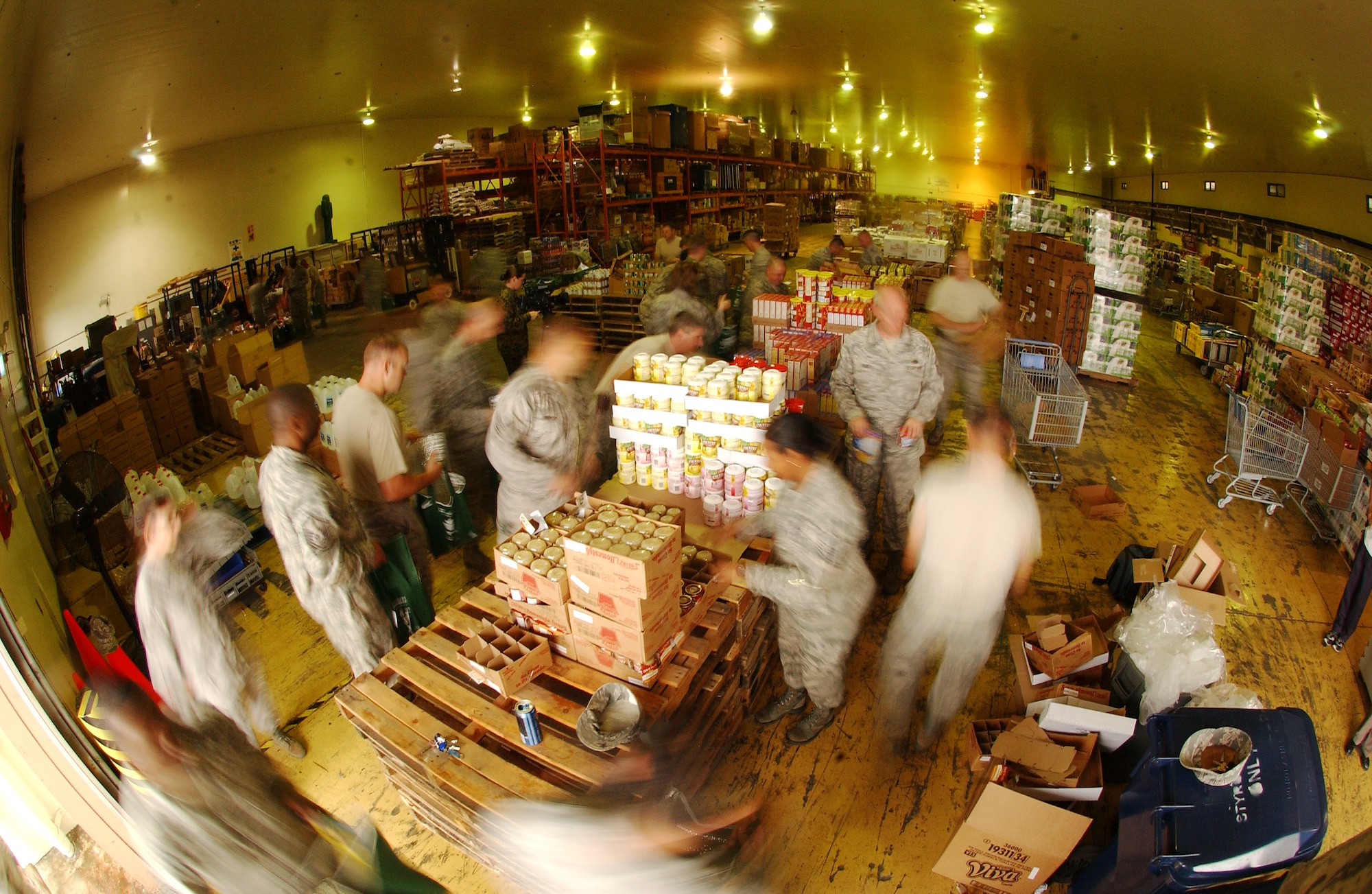 Military members prepare 275 bags filled with a Thanksgiving turkey and other canned goods for families in need at the Kadena Air Base Commissary as part of Operation Warmheart Nov. 24. Operation Warmheart is a charity designed to help enlisted personnel and their families with loans, grants, and other needs through fundraisers and donations. The 18th Wing Chapel donated more than $8K for this Thanksgiving food drive.   (U.S. Air Force photo/Tech. Sgt. Rey Ramon) 


