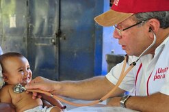 ILOPANGO, El Salvador – A Ministry of Health pediatrician performs an examination on a baby child Nov. 22 in Las Isletas, El Salvador. The JTF-Bravo Medical Element performed a Medical Civil Action Program, or MEDCAP, from Nov. 19 to 23 treating 2,987 people in several different cities affected by the El Salvador mudslides (U.S. Air Force photo/Staff Sgt. Chad Thompson).