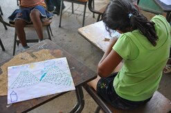 ILOPANGO, El Salvador – A child draws a picture of what she remembers of the floods for a psychiatric evaluation Nov. 21 in San Emigdio, El Salvador. The Ministry of Health provided psychologists for the Medical Civil Action Program, or MEDCAP, who performed 161 post-traumatic stress disorder screenings. The JTF-Bravo Medical Element performed the MEDCAP from Nov. 19 to 23 treating 2,987 people in several different cities affected by the El Salvador mudslides (U.S. Air Force photo/1st Lt. Jen Richard).