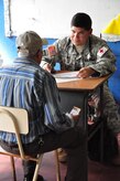 ILOPANGO, El Salvador – Army Dr. (Lt. Col.) Bart Diaz, Joint Task Force-Bravo flight surgeon, speaks with an elderly gentleman about his medical problems Nov. 20 in San Diego, El Salvador. JTF-Bravo Medical Element performed a Medical Civil Action Program, or MEDCAP, from Nov. 19 to 23 treating 2,987 people in several different cities affected by the El Salvador mudslides. (U.S. Air Force photo/Staff Sgt. Chad Thompson).