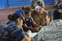 ILOPANGO, El Salvador – 2nd Lt. Johanna Vielman, Salvadoran military, translates for Air Force Senior Airman Ashley Carter, during a medical screening Nov. 20 in San Diego, El Salvador. JTF-Bravo Medical Element performed a Medical Civil Action Program, or MEDCAP, from Nov. 19 to 23 treating 2,987 people in several different cities affected by the El Salvador mudslides. (U.S. Air Force photo/Staff Sgt. Chad Thompson).