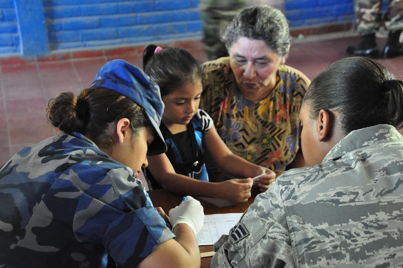 ILOPANGO, El Salvador – 2nd Lt. Johanna Vielman, Salvadoran military, translates for Air Force Senior Airman Ashley Carter, during a medical screening Nov. 20 in San Diego, El Salvador. JTF-Bravo Medical Element performed a Medical Civil Action Program, or MEDCAP, from Nov. 19 to 23 treating 2,987 people in several different cities affected by the El Salvador mudslides. (U.S. Air Force photo/Staff Sgt. Chad Thompson).