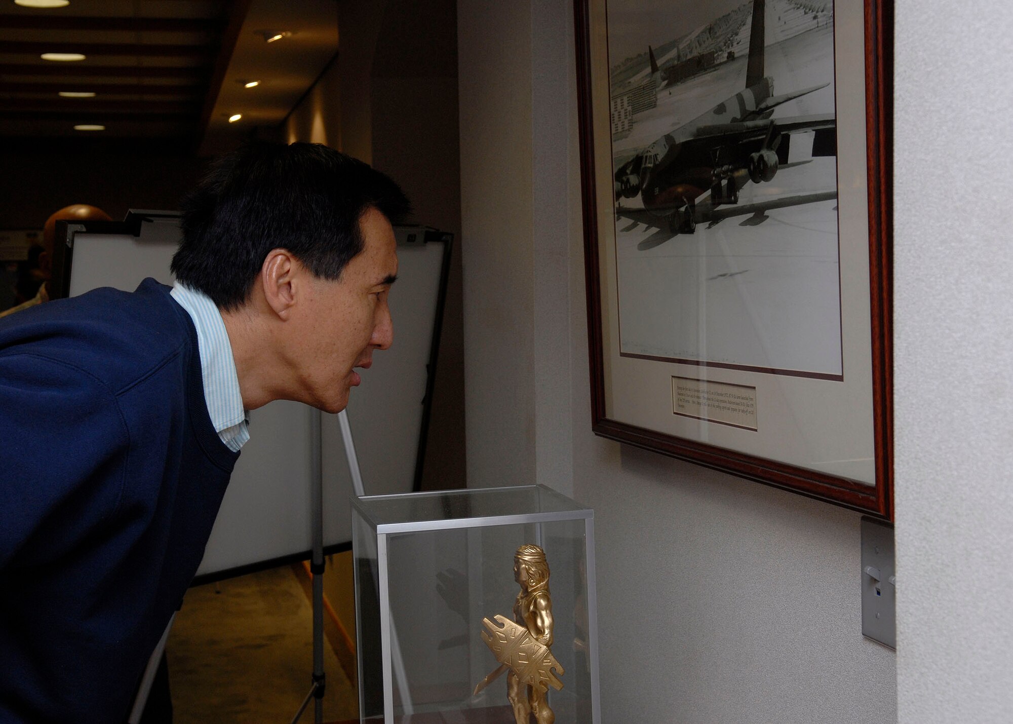 Steven Ai, President and CES of City Mill Co. Ltd. and member of the Air Force Civilian Advisory Council, looks at a B-52 historical photo during a refueling stop at Andersen Air Force Base, Guam Nov. 23. The group of four AFCAC members joinged Gen. Gary North, Pacific Air Forces commander, on a tour to Kunsan and Osan Air Bases, Republic of Korea Nov. 21-26. The purpose of the trip is for General North to celebrate Thanksgiving with the Airmen and for the civic leaders to get a better understanding of life for Airmen who are assigned to ROK. (U.S. Air Force photo/Tech. Sgt. Jerome S. Tayborn)