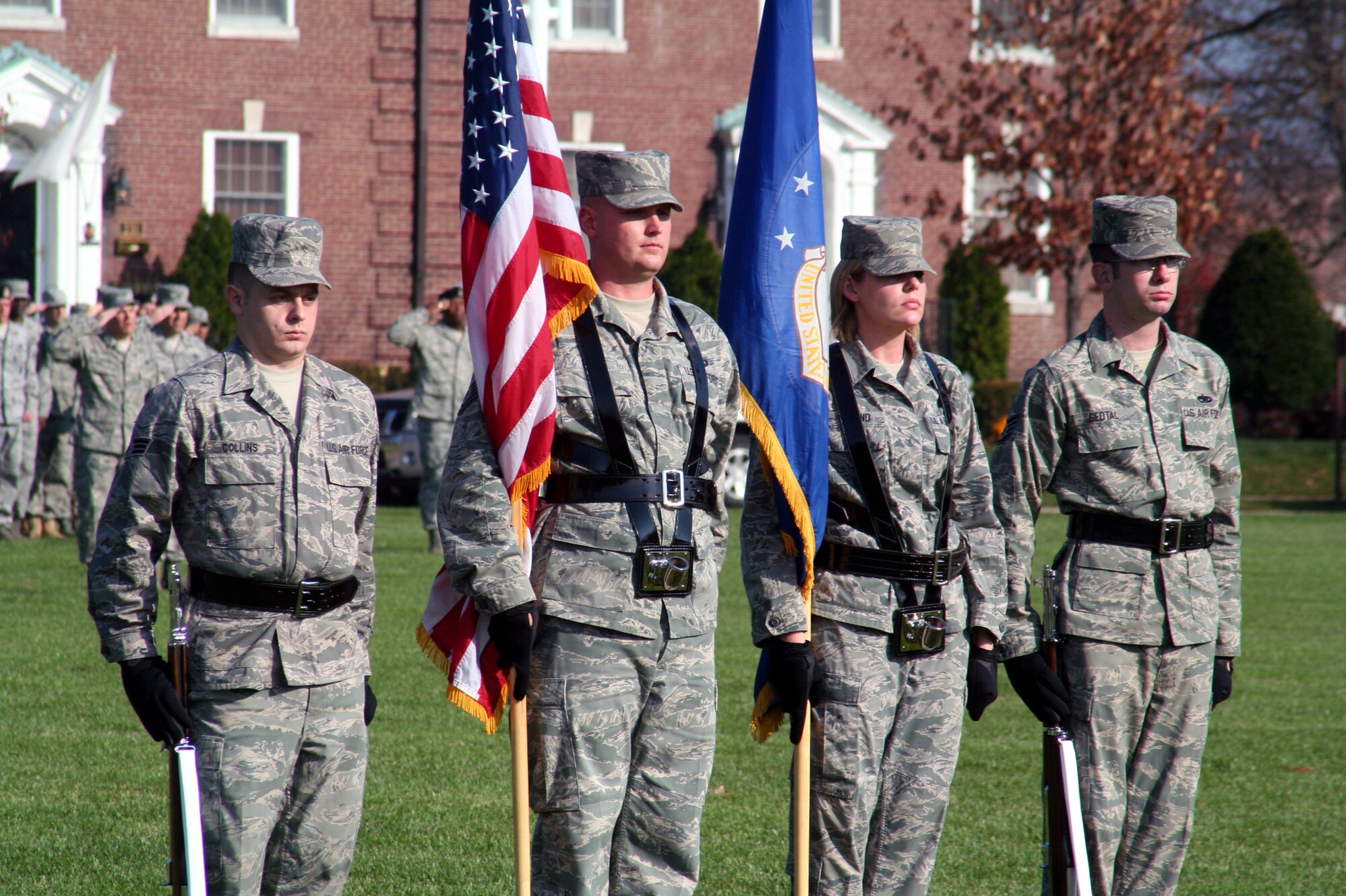 Airmen assigned to the color guard stand ready during the Air Mobility Command change of command ceremony on Nov. 20, 2009, at Scott Air Force Base, Ill.  During the ceremony, Gen. Raymond E. Johns Jr. took command of AMC. (U.S. Air Force Photo/Tech. Sgt. Scott T. Sturkol)