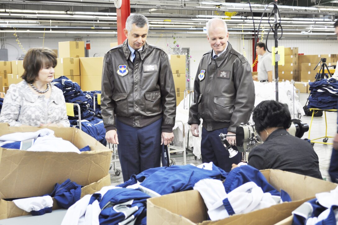 Cathy Griffith explains to Col. Roger Watkins and Chief Master Sgt. Rich Brackett how the Air Force's improved physical training uniform is made during a Nov. 3, 2009, tour of the facility in Columbus, Miss. Ms. Griffith is the American Power Source operations manager. Colonel Watkins is the 14th Flying Training Wing commander, and Chief Brackett is the 14th FTW command chief. (U.S. Air Force photo/Sonic Johnson)