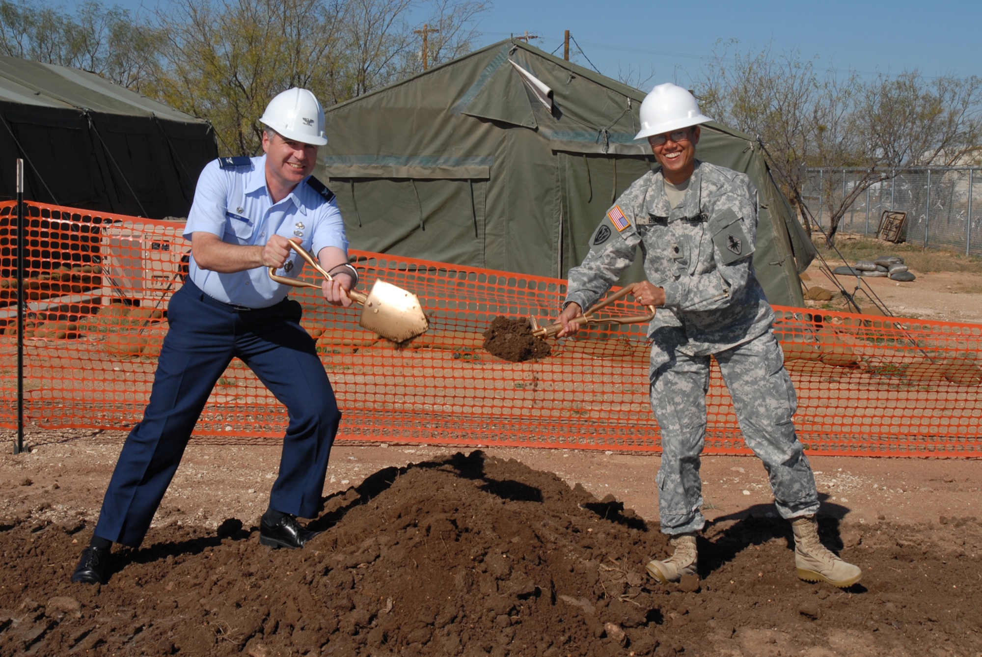 GOODFELLOW AIR FORCE BASE, Texas -- Col. Thomas Geary, 17th Training Wing commander, and Army Lt. Col. Bichson Bush, 344th Military Intelligence Battalion commander, perform the ceremonial ground-breaking for a new facility at Forward Operating Base Sentinel, Nov. 23, 2009. The new facility will allow for more realistic training in a simulated combat/field environment. (U.S. Air Force photo/Staff Sgt. Laura McFarlane)

