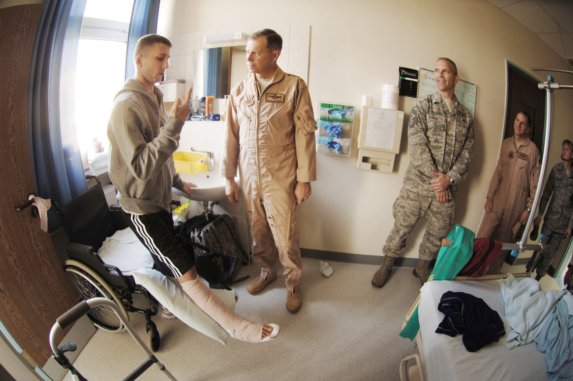 Gen. William M. Fraser III and Chief Master Sgt. Marty Klukas, (right), visit Landstuhl Regional Medical Center, Germany, Nov. 20, 2009. The leaders met hospital staff and wounded U.S. and coalition servicemembers like Polish Corporal Waldemar Amrozi, who explained how injuries he sustained in Afghanistan nearly cost the loss of his right leg. Since 2004, the hospital has treated more than 58,000 wounded U.S. and coalition servicemembers and civilians injured in Iraq and Afghanistan. General Fraser is the commander of Air Combat Command and Chief Klukas is the ACC command chief. (Defense Department photo/Master Sgt. Scott Wagers/Defense Media Activity Ramstein)