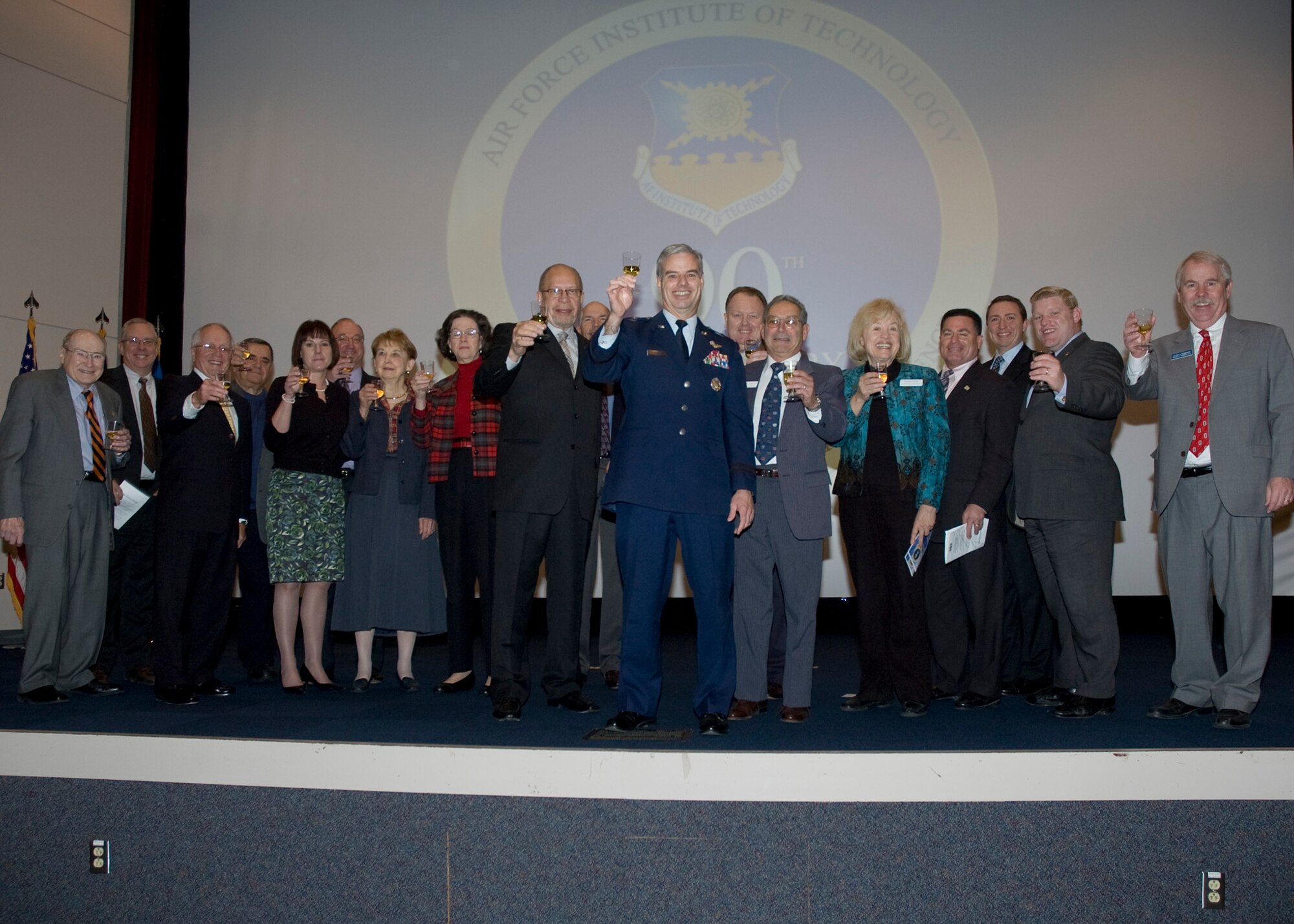 Air Force Institute of Technology Commandant, Brig. Gen Walter Givhan, offers a toast among a group of invited Distinguished Visitors on-hand to celebrate AFIT's 90th
anniversary (US Air Force Photo)
