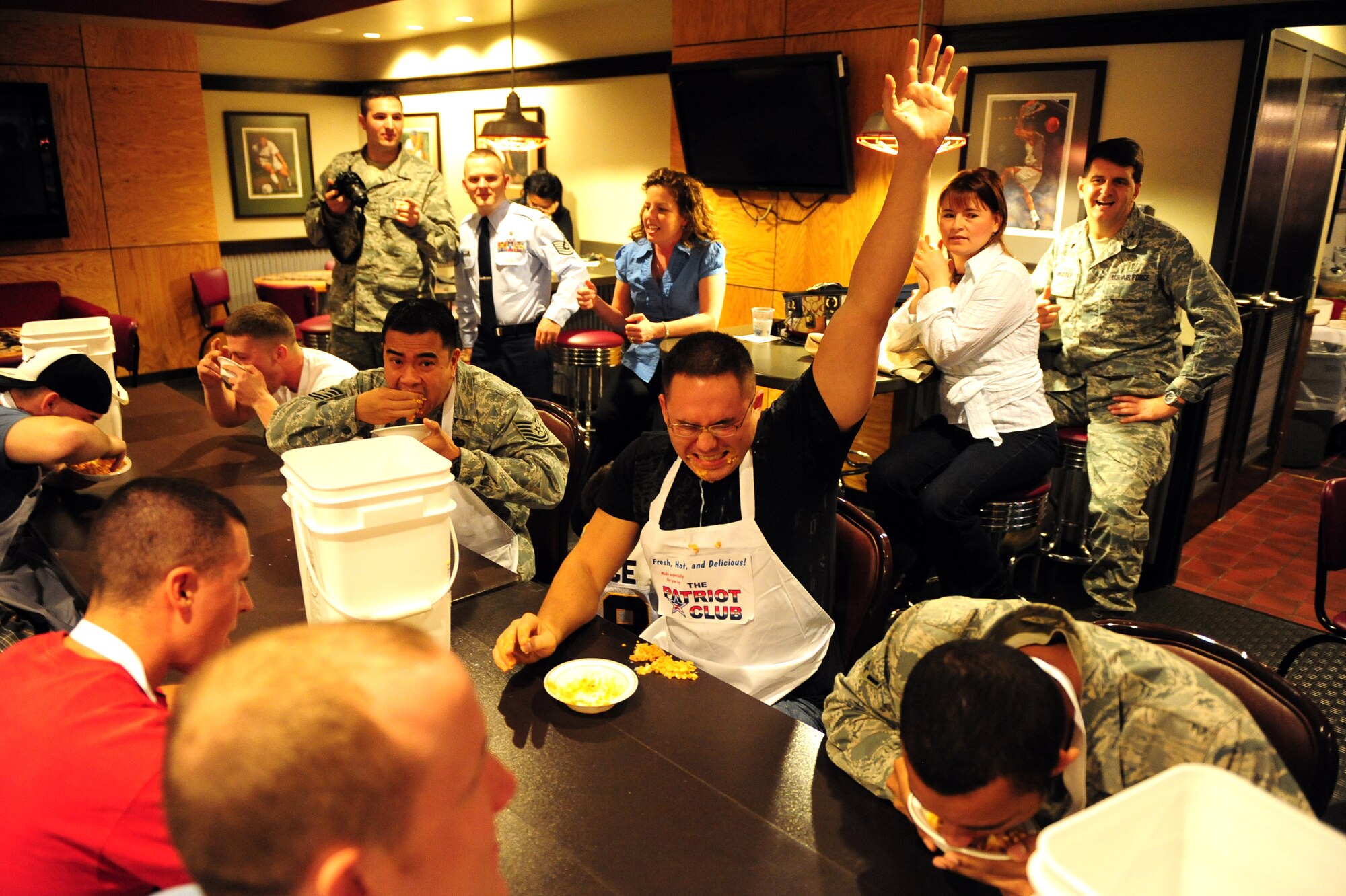 OFFUTT AIR FORCE BASE, Neb. - Senior Airman Michael Makela, 55th Force Support Squadron, raises his hand after downing a plate of ostrich eggs in cow brains within seconds after he put the bowl to his mouth during the Fear Factor competition at the Patriot Club Nov. 20.  Participants, with precautionary buckets nearby, downed four stomach-turning dishes for the chance to win cash prizes.

U.S. Air Force photo by Josh Plueger
