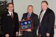 Retired Gen. Bruce Carlson, former Air Force Materiel Command commander,
accepts the Air Force Association's H.H. Arnold Fellowship Award from (left)
Jeff Liffick, AFA Wright Memorial Chapter #212 president, and (right) John
McCance, AFA Great Lakes region president, during a Nov. 20 recognition
breakfast at the Hope Hotel and Conference Center. General Carlson was
presented with the award for his encouragement and support of this year's
U.S. Air, Trade and Technology Expo. (Photo by Bill Pugh)