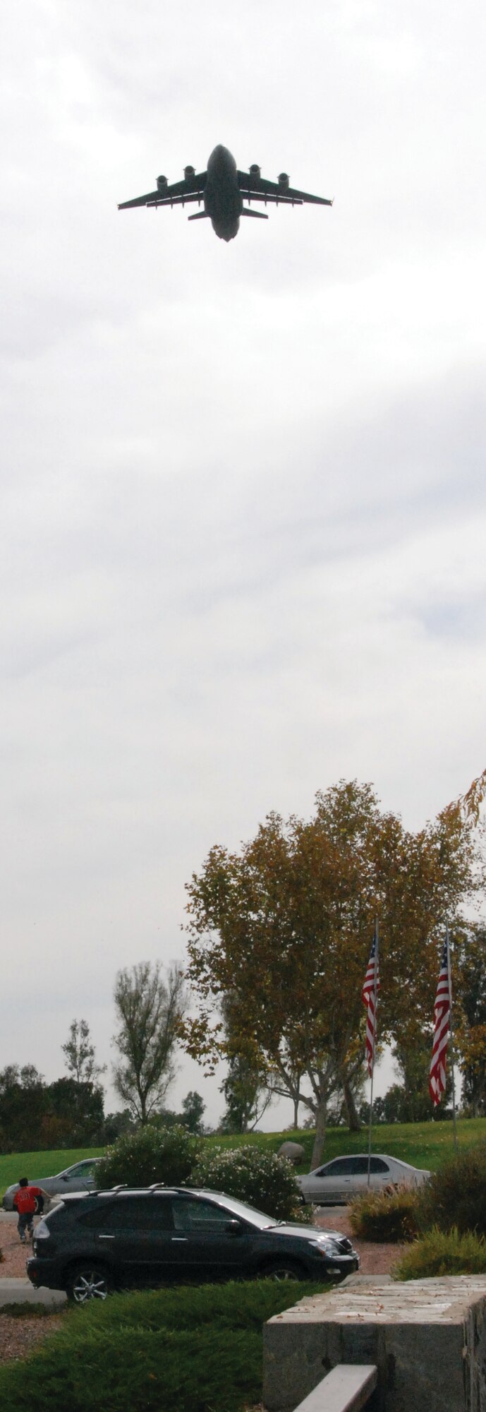 A C-17 from the 729th Airlift Squadron, March Air Reserve Base, flies over the ceremony. (U.S. Air Force photos by Megan Just)