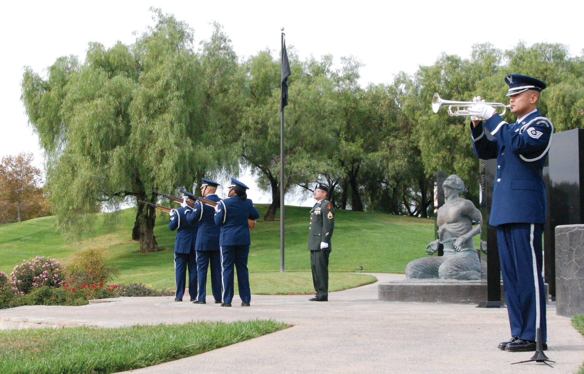 Sgt. Neil Ballecer plays Taps on the trumpet while members of the Blue Eagles Total Force Honor Guard render a rifle salute during the Daedalian Ceremony Nov. 11. (U.S. Air Force photos by Megan Just)