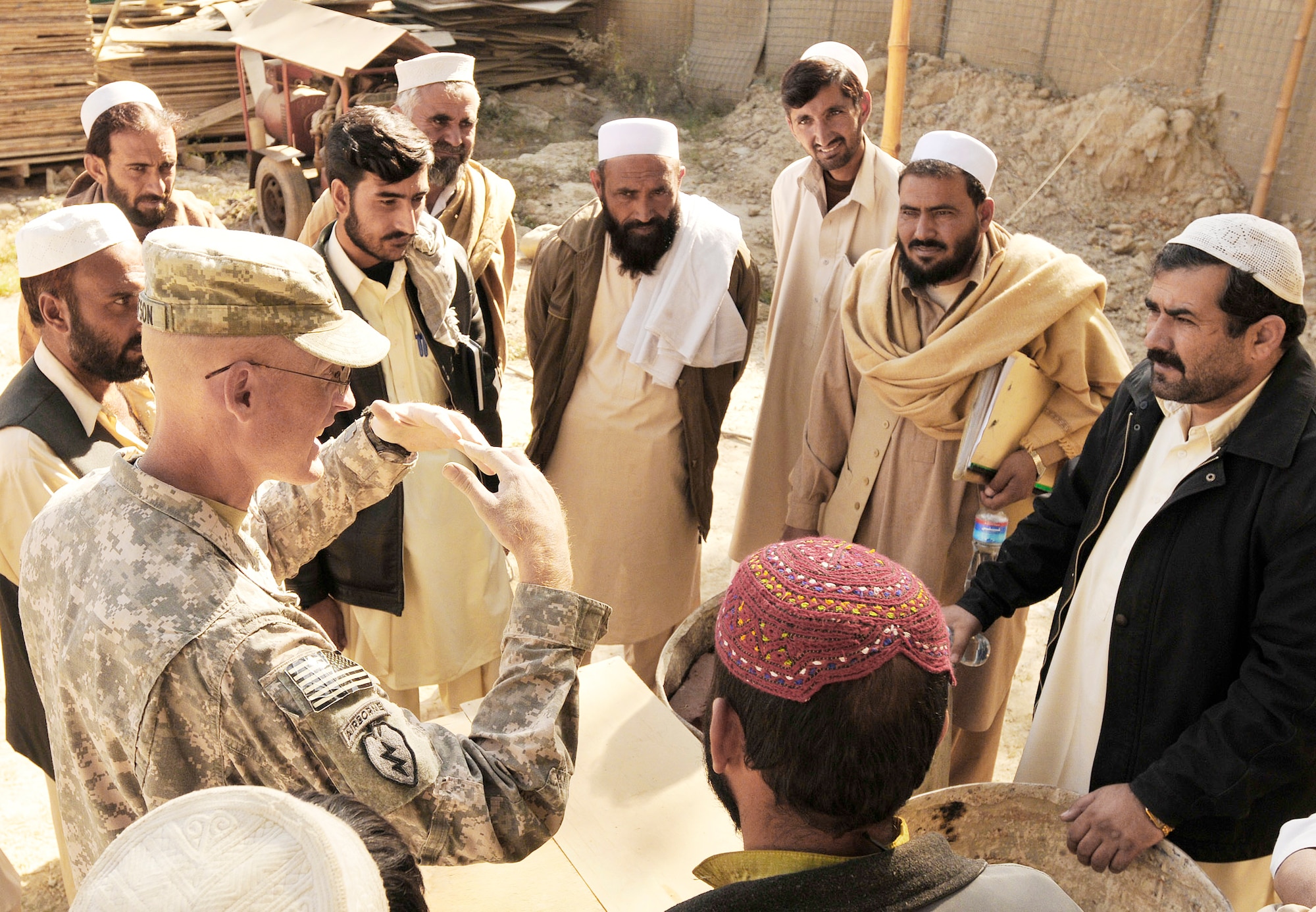 KHOST PROVINCE, Afghanistan - U.S. Navy Lt. Stephen J. Gustafson, Khost Provincial Reconstruction Team engineer, teaches proper masonry supply storage to local engineers, construction contractors, and foremen during a monthly contractor training session held at the Civil Military Operations Center, Khost, Afghanistan, Nov. 14. Engineers from the Khost PRT provided construction quality assurance training to locals in order to facilitate high quality construction practices in the region. (Photo by U.S. Air Force Staff Sgt. Stephen J. Otero, Khost PRT Public Affairs)

