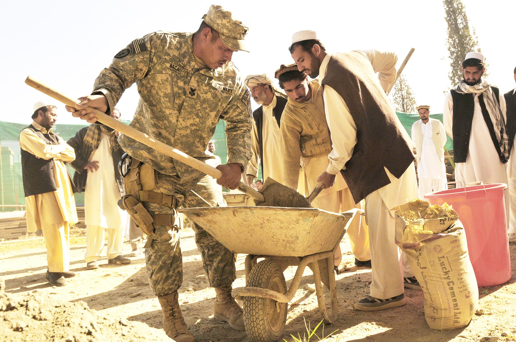 KHOST PROVINCE, Afghanistan - U.S. Navy Builder 1st Class Iascc Baca, Khost Provincial Reconstruction Team engineer, teaches proper mortar mixing technique to local engineers, construction contractors, and foremen during a monthly contractor training session held at the Civil Military Operations Center, Khost, Afghanistan, Nov. 14. Engineers from the Khost PRT provided construction quality assurance training to locals in order to facilitate high quality construction practices in the region. (Photo by U.S. Air Force Staff Sgt. Stephen J. Otero, Khost Provincial Reconstruction Team Public Affairs)