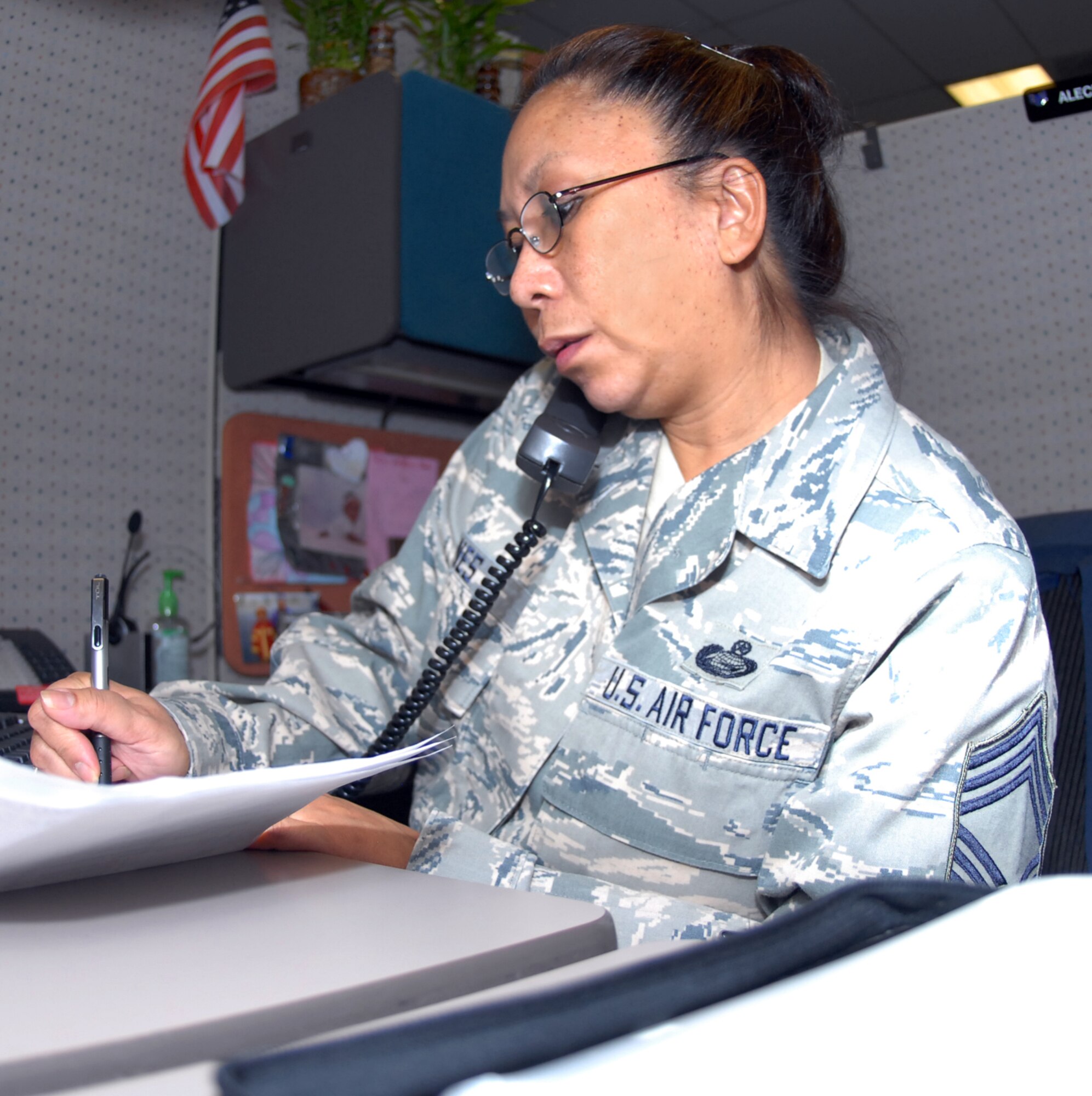 Chief Master Sgt. Fatima Jones, HQ Air Reserve Personnel Center Superintendant, provides assistance at the Total Force Service Center – Denver Contact Center here Nov. 20. Senior leaders at ARPC volunteered to man the phones to allow Contact Center employees to attend their holiday function. (U.S. Air Force photo by Dwayne Beuthel)
