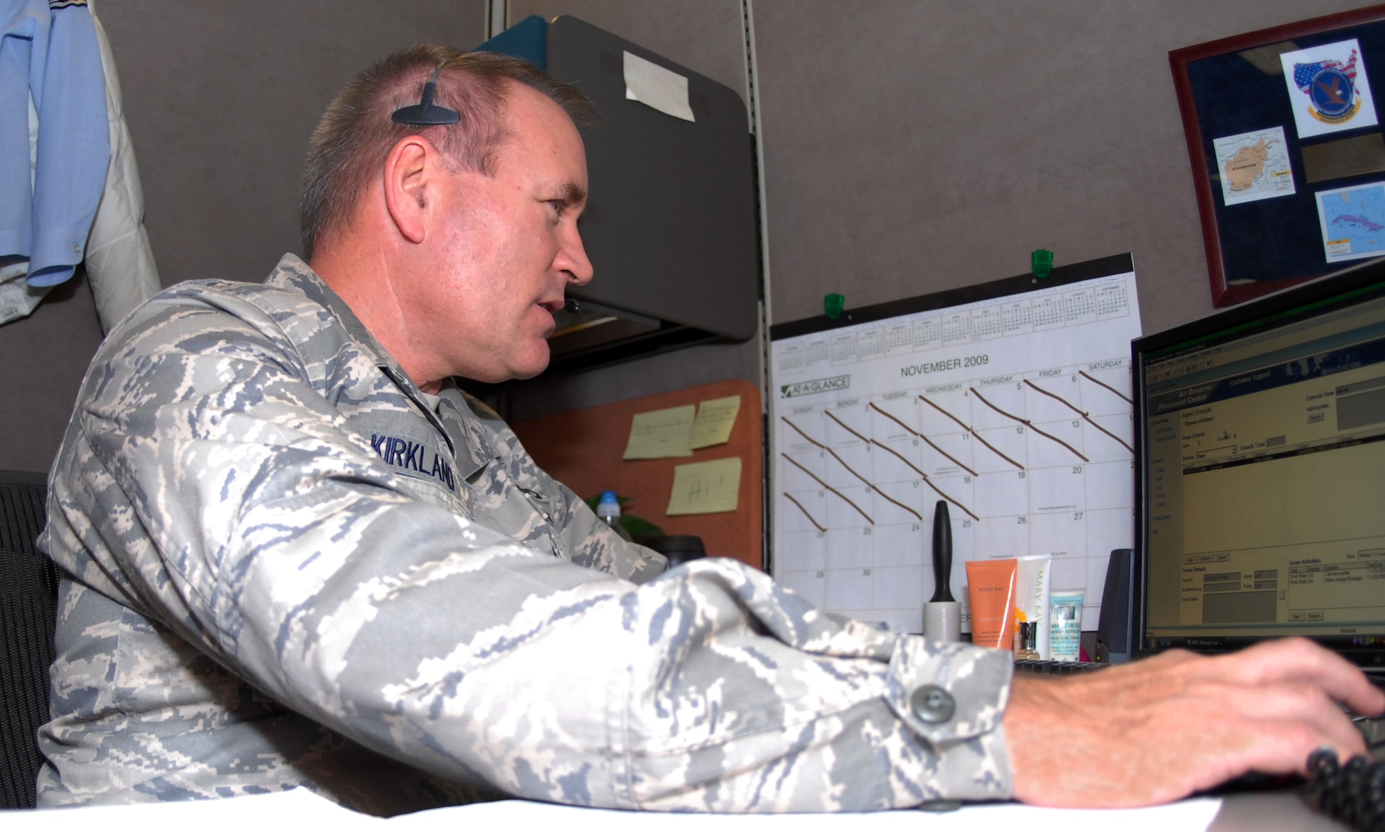 Maj. Thomas Kirkland, AFSO21 Process Manager, assists customers at the Total Force Service Center – Denver here Nov. 20. Members of the Air Reserve Personnel Center leadership provided phone coverage to allow Contact Center personnel to attend a holiday function. (U.S. Air Force photo by Dwayne Beuthel)