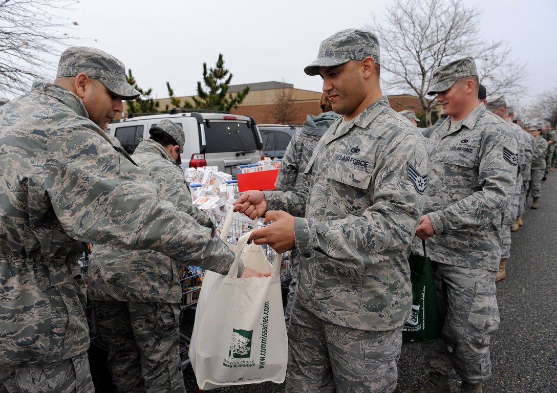 LANGLEY AIR FORCE BASE, Va. – Eighty Langley personnel form an assembly line to pack bags with Thanksgiving favorites during Operation Warmheart Nov. 23. Operation Warmheart is a First Sergeants' Association community outreach program designed to support Airmen and their families during the holiday season. (U.S. Air Force photo/Airman Rebecca Montez)