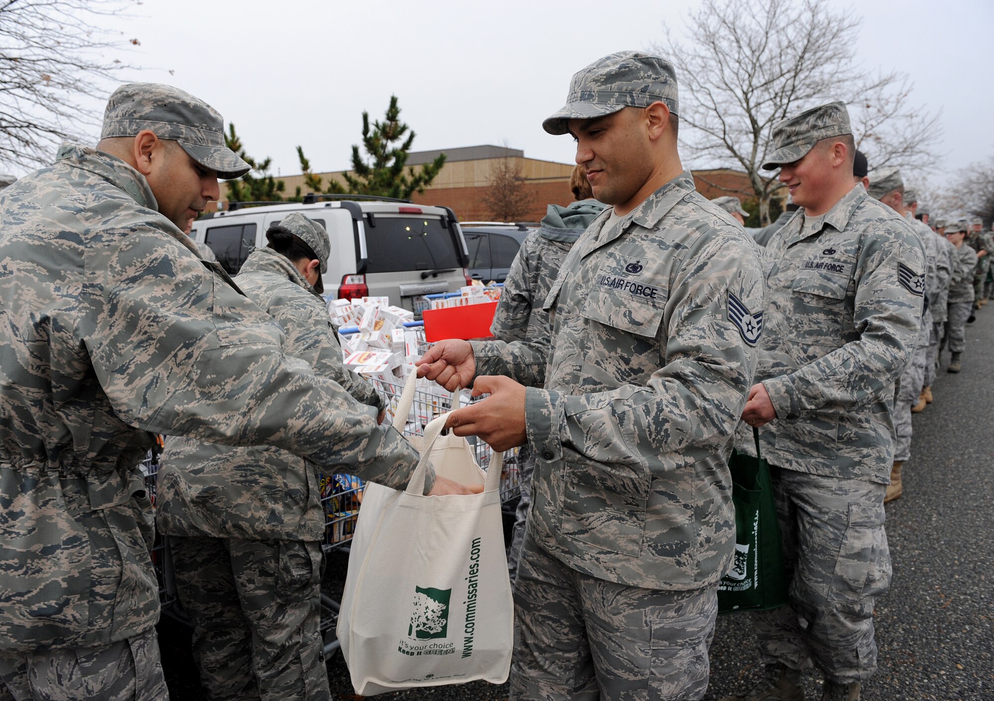 LANGLEY AIR FORCE BASE, Va. – Eighty Langley personnel form an assembly line to pack bags with Thanksgiving favorites during Operation Warmheart Nov. 23. Operation Warmheart is a First Sergeants' Association community outreach program designed to support Airmen and their families during the holiday season. (U.S. Air Force photo/Airman Rebecca Montez)