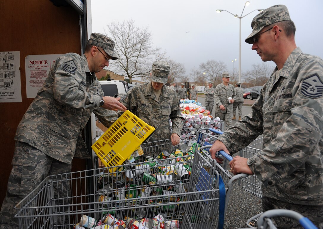 LANGLEY AIR FORCE BASE, Va. – First Sergeants load cans of food into shopping carts during Operation Warmheart Nov. 23. Operation Warmheart is a First Sergeants' Association community outreach program designed to support Airmen and their families during the holiday season. (U.S. Air Force photo/Airman Rebecca Montez)
