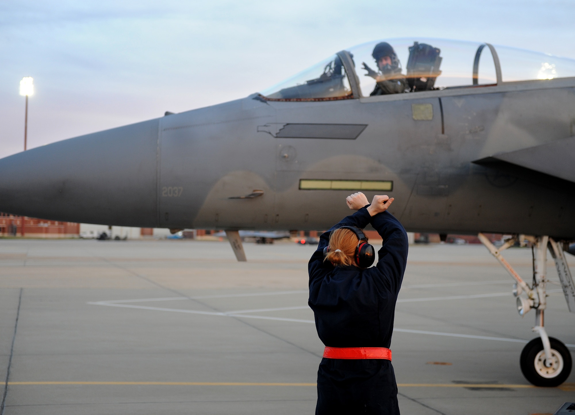 LANGLEY AIR FORCE BASE, Va. -- Airman 1st Class Jessica Hinves, 71st Fighter Squadron Aircraft Maintenance Unit F-15C Eagle crew chief, marshals Capt. Michael Fritts, 71st FS pilot, and his aircraft upon arrival Nov. 21 following weapons school support at Nellis Air Force Base, Nev. Captain Fritts and his team contributed weapons systems and adversary role support to pilots training there. (U.S. Air Force photo/Airman Rebecca Montez)