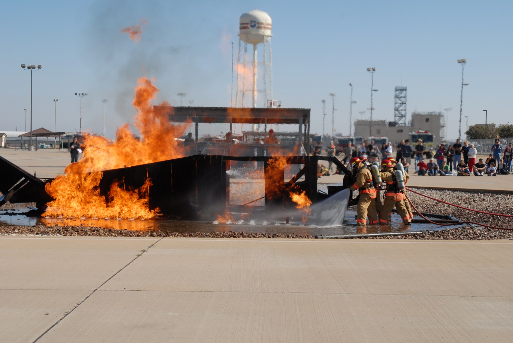 GOODFELLOW AIR FORCE BASE, Texas -- Instructors from the 312th Training Squadron demonstrate aircraft firefighting for members of the San Angelo community, Nov. 21, 2009, during one of the events for Community Appreciation Day. Other events during the day included military working dog demonstrations, a live demonstration of military operations in urban terrain, and a bus tour of the base. (U.S. Air Force photo/Staff Sgt. Laura R. McFarlane)
