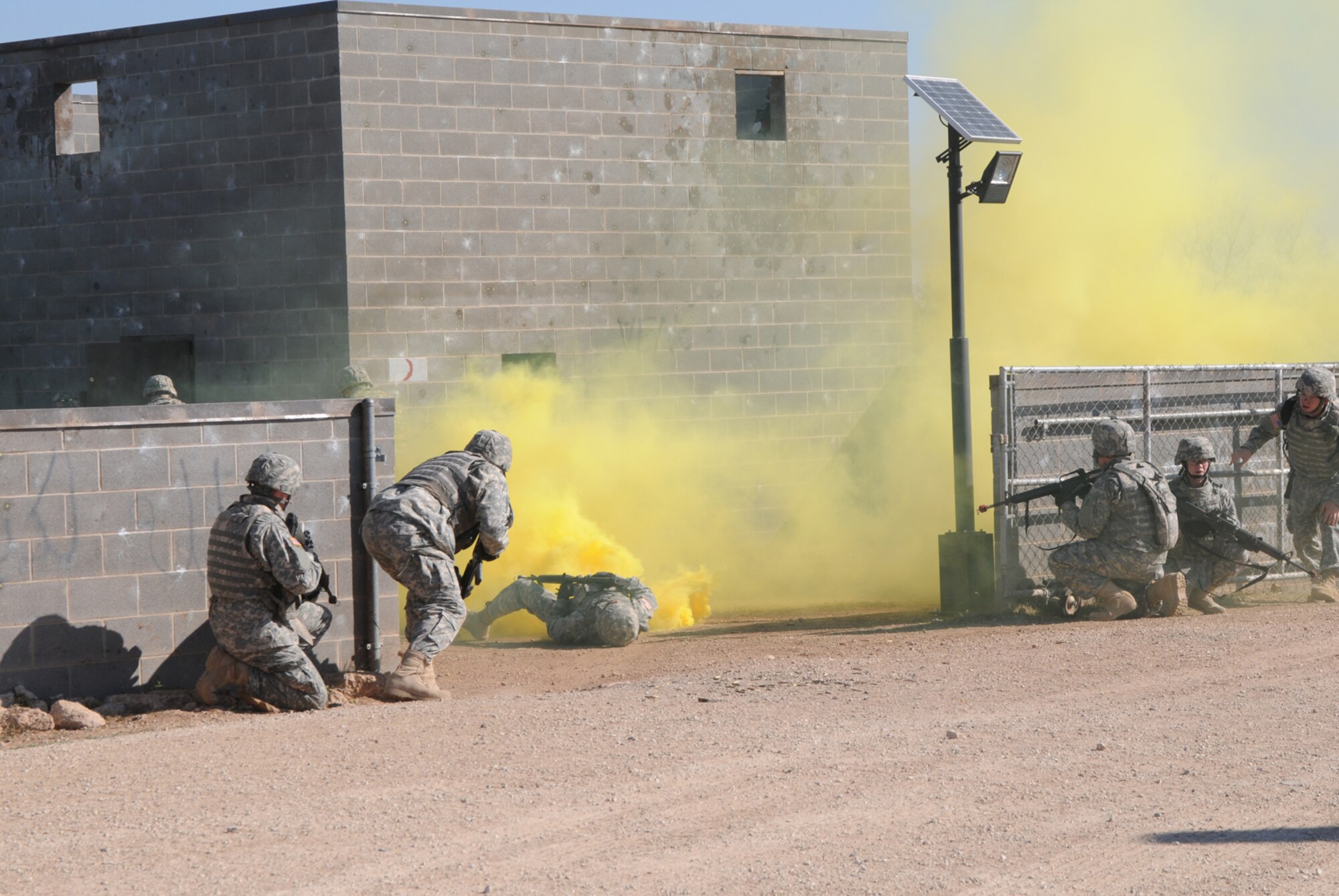 GOODFELLOW AIR FORCE BASE, Texas -- Soldiers from the 344th Military Intelligence Battalion Alpha Company demonstrated coming under an ambush in a simulated small Iraqi village during Community Appreciation Day, Nov. 21, 2009. Other events during the day included military working dog demonstrations, firefighting exercises, a Marine Corps Martial Arts Program demonstration, and a bus tour of the base. (U.S. Air Force photo/Airman Clayton Lenhardt)
