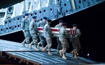 A U.S. Army carry team transfers the remains of Army Staff Sgt. John J. Cleaver., of Marysville, Wash. at Dover Air Force Base, Del., Nov. 21, 2009. Staff Sgt. Cleaver was assigned to Company E, 782nd Brigade Support Bat, Fort Bragg, NC.  (U.S. Air Force  photo by Brianne Zimny)