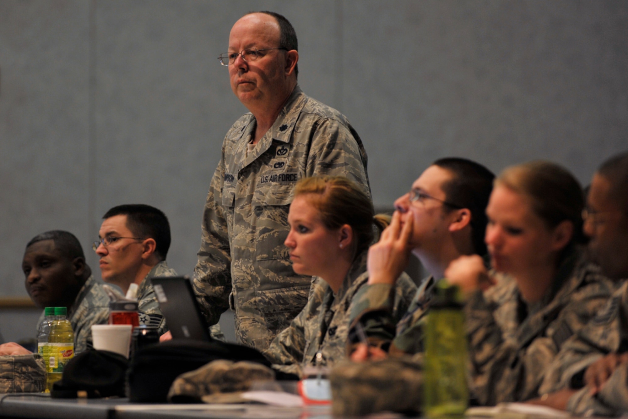 The 931st Air Refueling Group's Lt. Col. Kimberly Thompson (standing) waits for information with his Regular Force counterparts at McConnell Air Force Base, Kan., during tabletop exercise on Nov. 17. Colonel Thompson is commander of the 931st Civil Engineer Squadron, an Air Force Reserve unit at McConnell. The exercise was the first to feature Reservists from the 931st fully integrated with their Regular Force counterparts from the 22nd. (U.S. Air Force photo/Master Sgt. Jason Schaap)