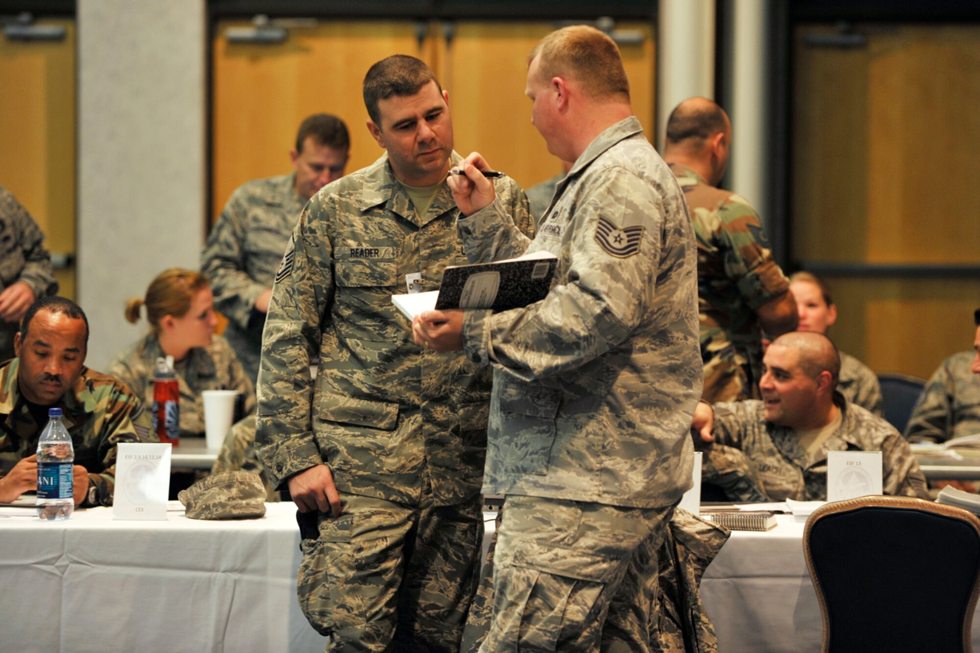 Master Sgt. Robert Reader and Tech. Sgt. Michael Rooney talk about the security situation during tabletop exercise at McConnell Air Force Base, Kan., on Nov. 17. Sergeant Reader is the security forces chief for the 931st Air Refueling Group and Sergeant Rooney is a security forces member of the 22nd Air Refueling Wing. The McConnell exercise was the first to feature Reservists from the 931st fully integrated with their Regular Force counterparts from the 22nd. (U.S. Air Force photo/Master Sgt. Jason Schaap)