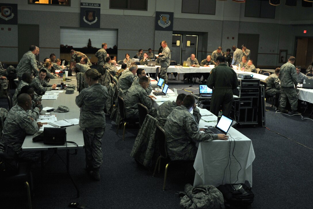 Reservists and Regular Force Airmen assigned to McConnell Air Force Base, Kan., work together during a tabletop exercise at the base on Nov. 17. The exercise was  the first at McConnell to feature 931st Air Refueling Group Reservists fully integrated with their counterparts from the 22nd Air Refueling Wing. (U.S. Air Force photo/Master Sgt. Jason Schaap)