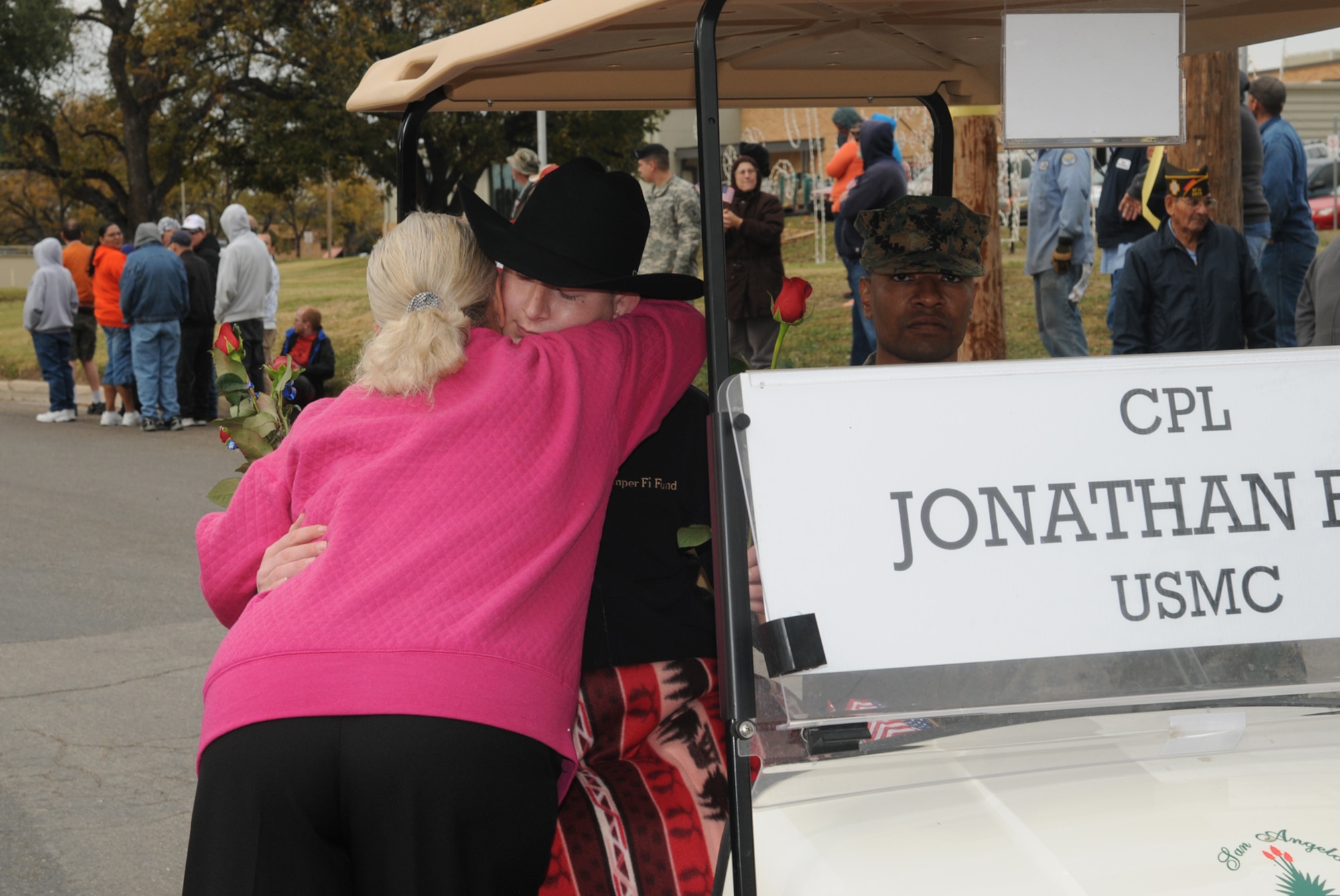 SAN ANGELO, Texas -- A local resident gives Marine Corps Cpl. Jonathan Rist a hug during the Hunt for Heroes Parade, Nov. 20, 2009.  The local Hunt for Heroes Parade welcomes wounded servicemembers and acknowledges their sacrifices. (U.S. Air Force photo/Airman Clayton Lenhardt)
