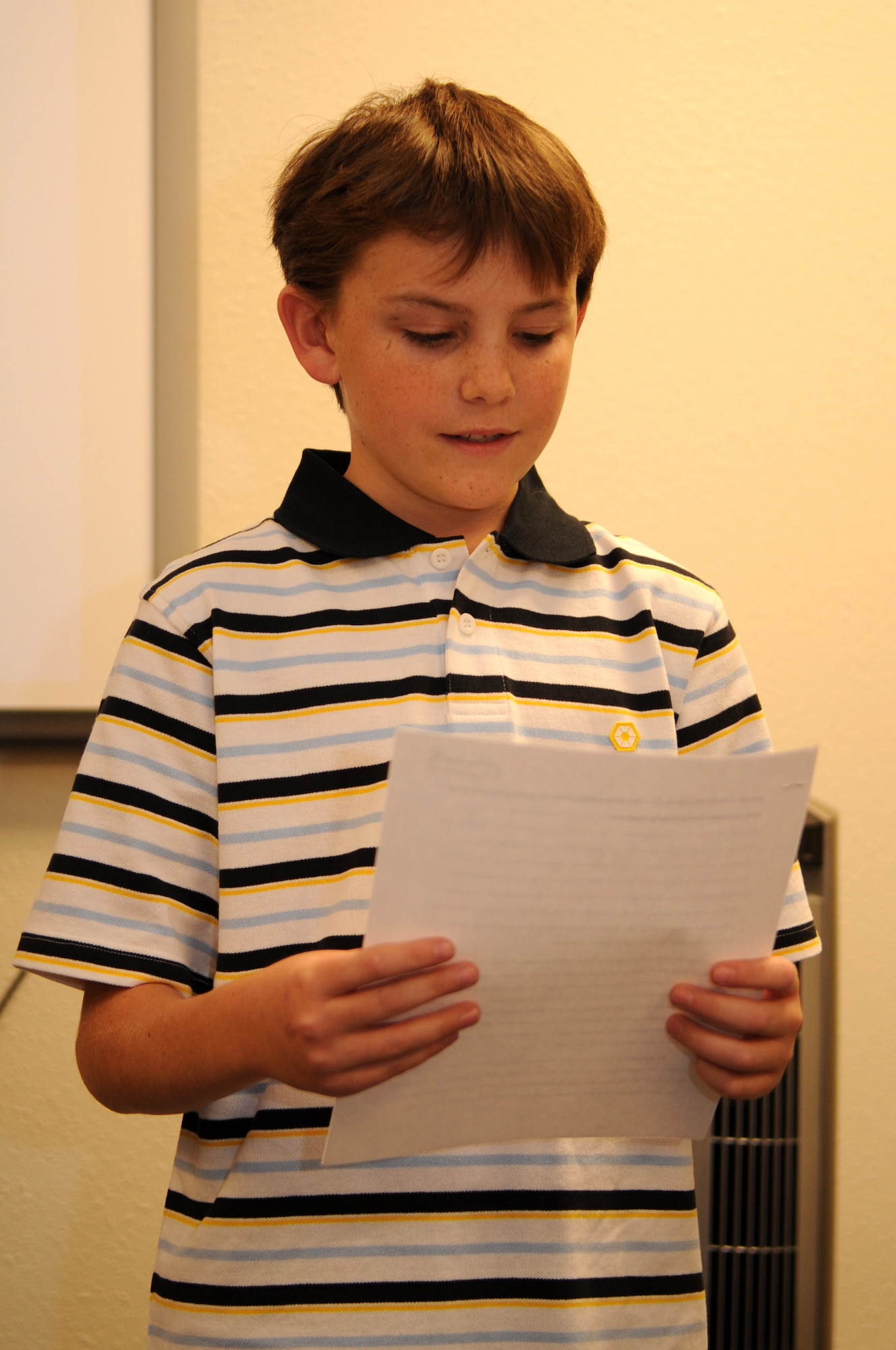 HOLLOMAN AIR FORCE BASE, N.M. -- Hunter Broesche, 12, reads his winning essay titled 'My Military Family' during the art and essay contest awards presentation at the Airman and Family Readiness Center here Nov. 19. The contest was held by the A&FRC in observation of the Month of the Military Family. (U.S. Air Force photo by Airman 1st Class Sondra Escutia)