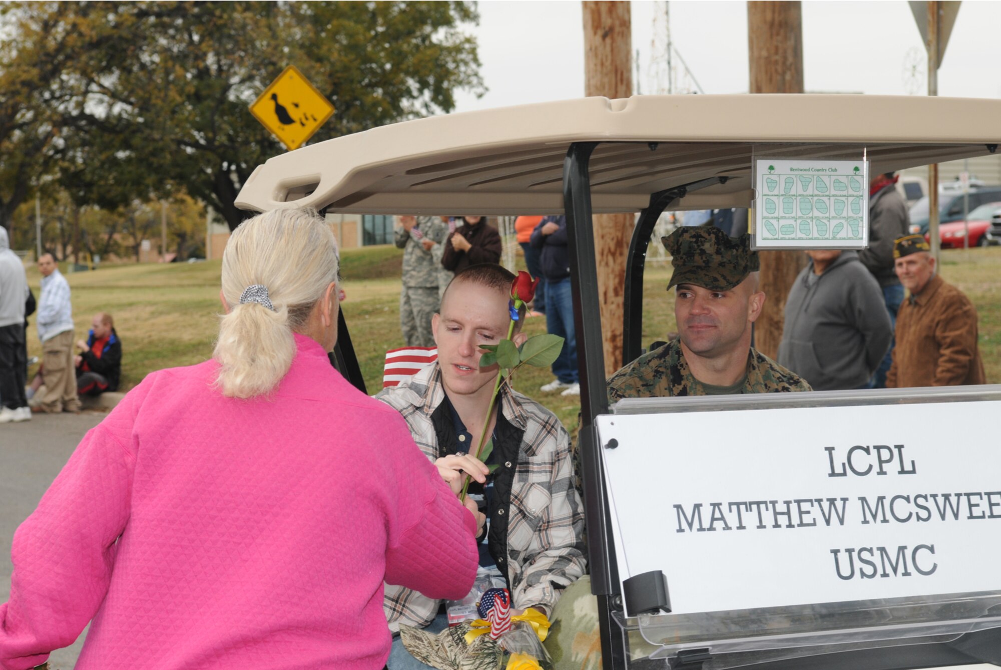 SAN ANGELO, Texas -- Marine Corps Lance Cpl. Matthew McSweeney accepts a rose from a local resident during the Hunt for Heroes Parade, Nov. 20, 2009.  The local Hunt for Heroes Parade welcomes wounded servicemembers and acknowledges their sacrifices. (U.S. Air Force photo/Airman Clayton Lenhardt)
