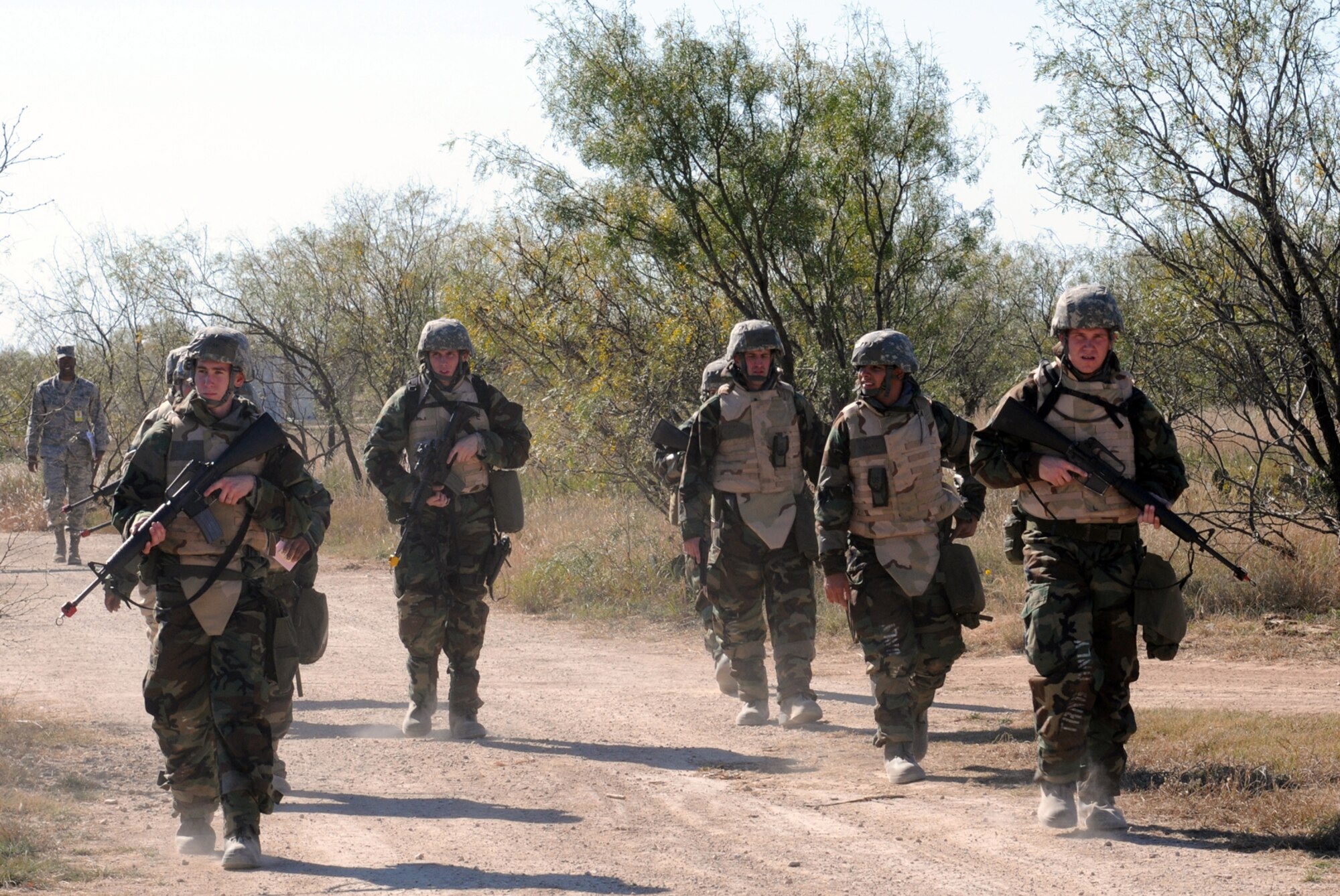 GOODFELLOW AIR FORCE BASE, Texas -- A reconnaissance patrol, clad in chemical protective gear, returns to Forward Operating Base Sentinel during a field training exercise, Nov. 19, 2009. FOB Sentinel is used to simulate real world conditions and scenarios at Goodfellow. (U.S.  Air Force photo/Airman Clayton Lenhardt)

