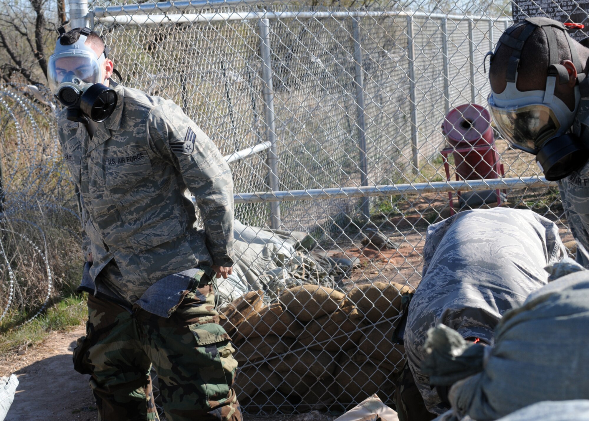 GOODFELLOW AIR FORCE BASE, Texas -- Senior Airman Jeffery Hart, 17th Training Group, dons his chemical protective gear during a field training exercise at Forward Operating Base Sentinel, Nov. 19, 2009. FOB Sentinel is used to simulate real world conditions and scenarios at Goodfellow. (U.S. Air Force photo/Airman Clayton Lenhardt)
