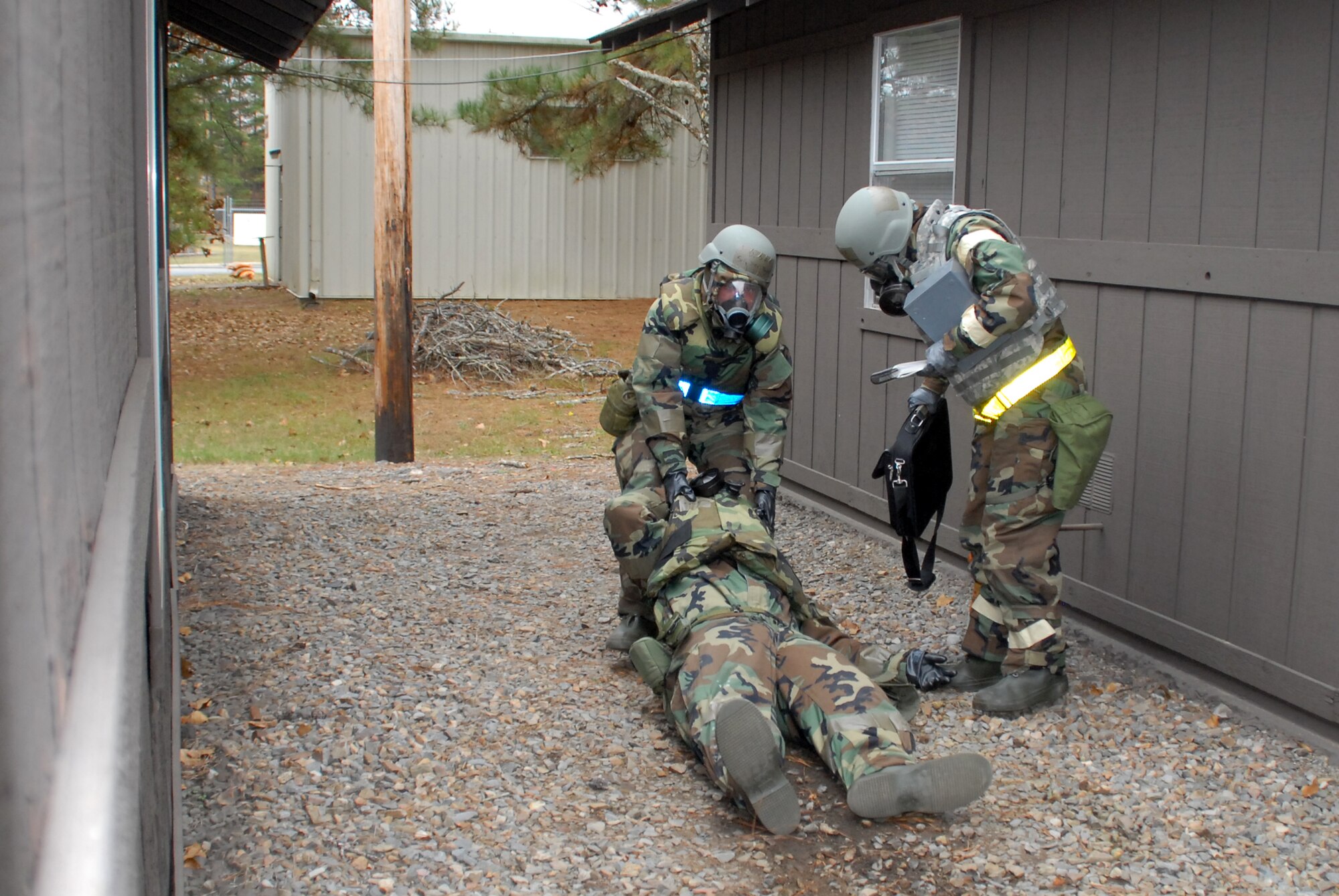 Senior Airman Jacob Taylor, 19th Comptroller Squadron financial management analyst; and Staff Sgt. Amber Rose, 19th Comptroller Squadron customer service NCO-in-charge; react to a missile attack on their bunker by dragging 1st Lieutenant Sean Andrews, 19th Comptroller Squadron, customer service officer-in-charge, to a safe location to perform self-aid and buddy care during a base exercise Nov. 17.  (U.S. Air Force photo by Senior Airman Michael Watkins)