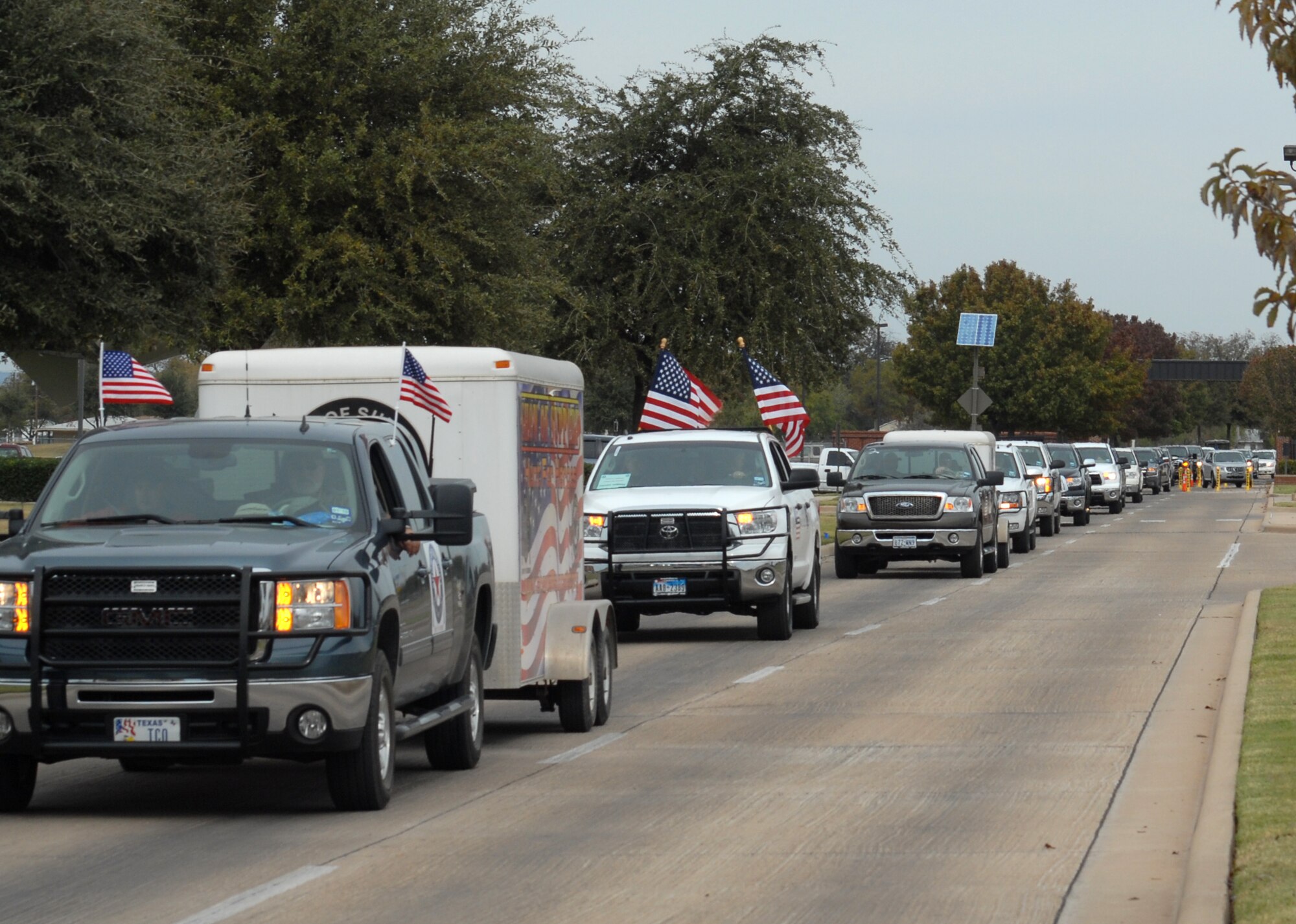 A caravan of vehicles with wounded veterans aboard arrive at Goodfellow AFB, Texas on Nov. 20.  25 wounded veterans took part in the annual Hunt for Heroes event in West Texas, hosted by the Show of Support Military Hunt Inc., a nonprofit organization.  The criteria for the hunt are the veterans have to be wounded or disfigured and discharged from the military. (U.S. Air Force photo/Robert D. Martinez)