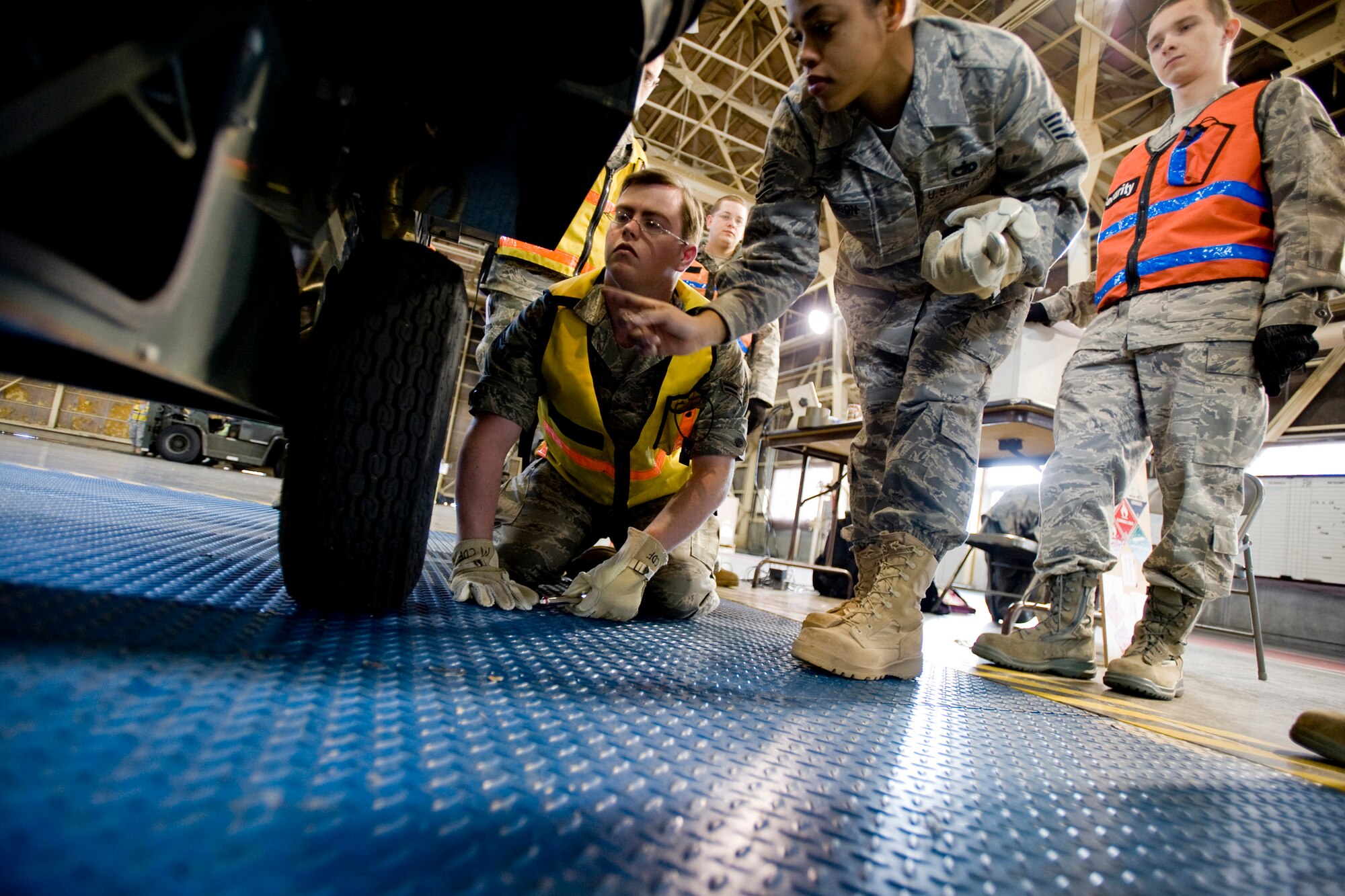 MISAWA AIR BASE, Japan -- Staff Sgt. Charice Roberson, out-bound personal property supervisor, and Airman 1st Class Chris Skinner, customer service journeyman, 35th Logistics Readiness Squadron, check a generator's tire pressure during cargo deployment function training Nov. 20 at Hanger 949. This was the first installment of proposed quarterly training for the team. In the past, team members were trained by slide presentations and only received hands-on training during exercises. (U.S. Air Force photo/Senior Airman Jamal D. Sutter)