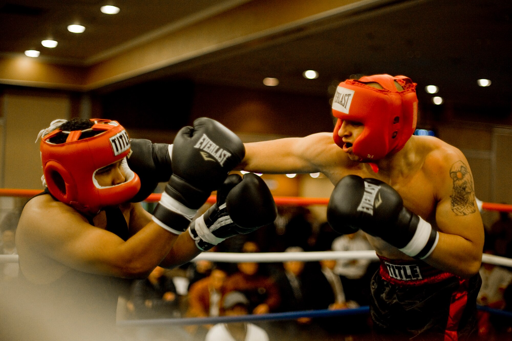 MISAWA AIR BASE, Japan -- Jeremy Perez, a New York City native, lands a right cross against Tony Lewis, a Las Vegas native, during their Friday Night Fight Night bout Nov. 20 at the Collocated Club. Tickets for the event were sold out before doors opened, but fans who couldn't get a seat were allowed to watch the fights on televisions throughout the Collocated Club. (U.S. Air Force photo/Senior Airman Jamal D. Sutter)