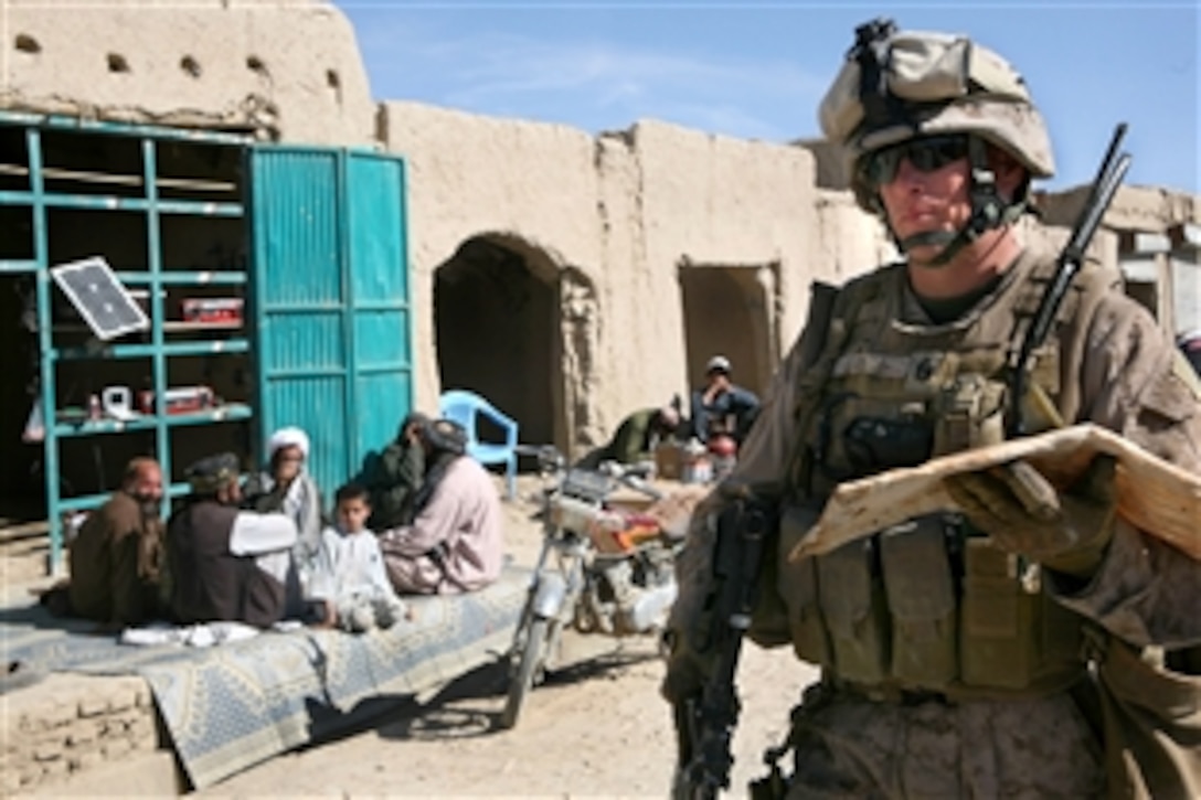 Marine Gunnery Sgt. John W. Leroy brings back bread from a local bakery at the Balaclava bazaar after a security shura at the governor's office in the Garmsir district, Afghanistan, Nov. 19, 2009. U.S. Marine Corps and Afghan national security force leaders met with the Garmsir district governor to discuss security issues and concerns. Leroy is assigned to Headquarters and Service Company, 2nd Battalion, 2nd Marine Regiment.