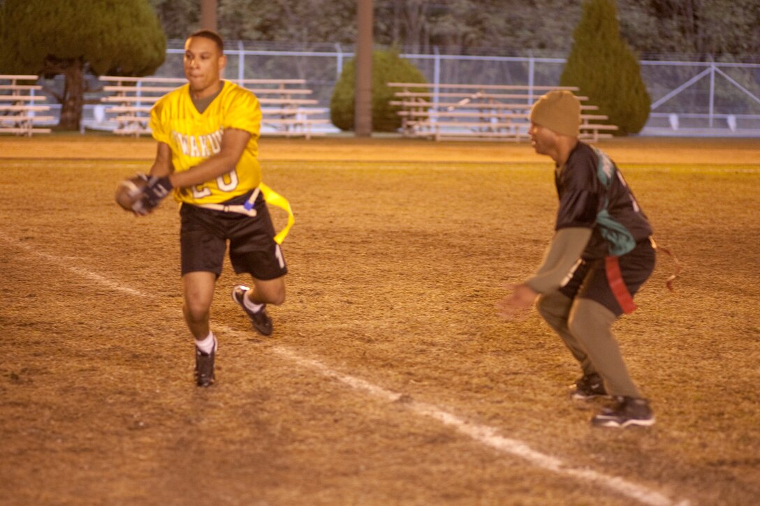 Cougar Bait receiver Isaiah Peart prepares to lateral the football upon running into Diamondback defensive lineman Joel Montez in an intramural flag football game at Northside field here Nov. 24. Defensively, Peart was able to intercept two completion attempts by the Diamondbacks.