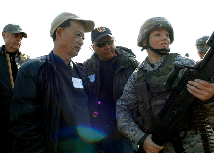 Airman Ali Rickman, 8th Security Forces Squadron, explains operations procedures for firing the M-24B to members of the Air Force Civilian Advisotry Council Nov. 23 at Kunsan Air Base, Republic of Korea, The  civic leaders joined Gen. Gary North, Pacific Air Forces commander, on a tour to Kunsan and Osan Air Bases, ROK, Nov. 21-26. The purpose of the trip is for General North to celebrate Thanksgiving with the Airmen and to provide the civic leaders a better understanding of life for Airmen assigned to the ROK. (U.S. Air Force photo/Tech. Sgt. Jerome S. Tayborn)     