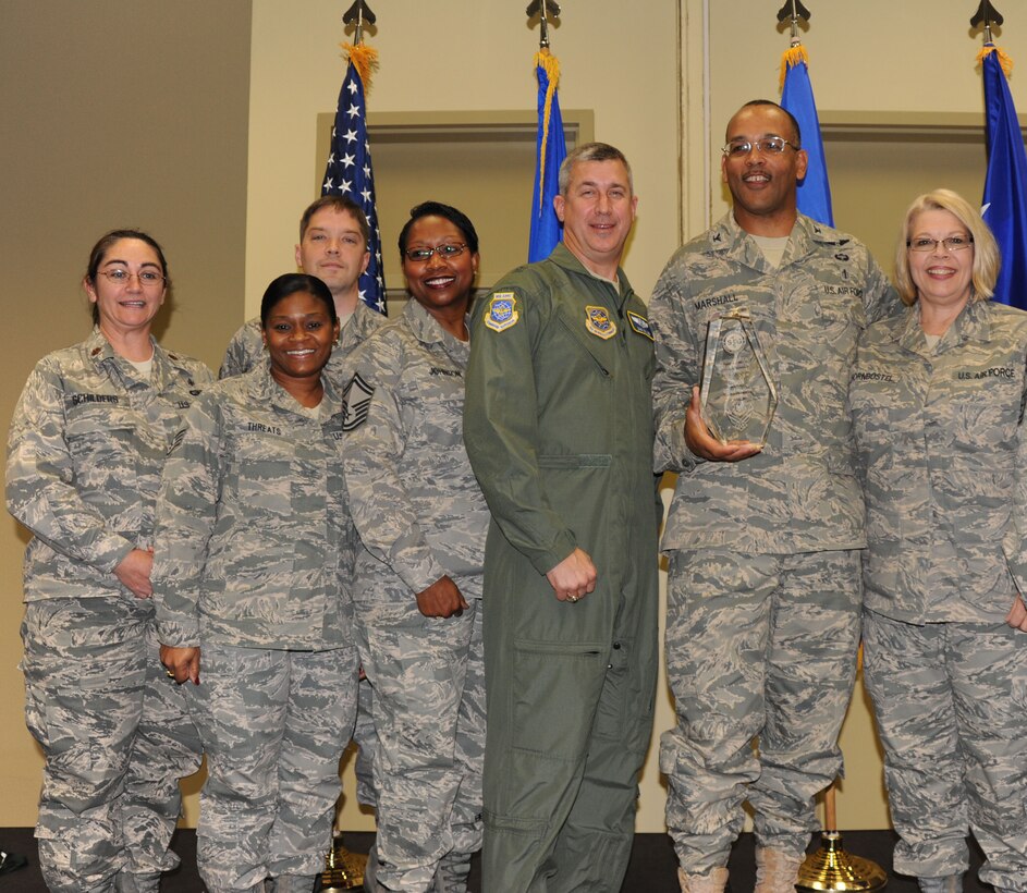 The winner of the Outstanding Medical Squadron without a Generation Mission is the 932nd Medical Squadron from Scott Air Force Base, Ill.  Members gathered to receive the award during an AMSUS banquet in downtown Saint Louis.  Their former commander, Brig. Gen. Dan Gillen, center, was among those who congratulated them.  Their outstanding accomplishments in support of Operations Enduring Freedom, Iraqi Freedom and Joint Task Force-Horn of Africa sent unit members on deployments around the globe to help others.  Seven members assigned to three critical care air transport teams flew a total of 67 missions, logged 532 flying hours and transported 162 critically wounded patients.  Wing personnel were also noted for their volunteerism with flood relief, hurricanes and programs for the underprivileged.  (U.S. Air Force photo/Maj. Stan Paregien)