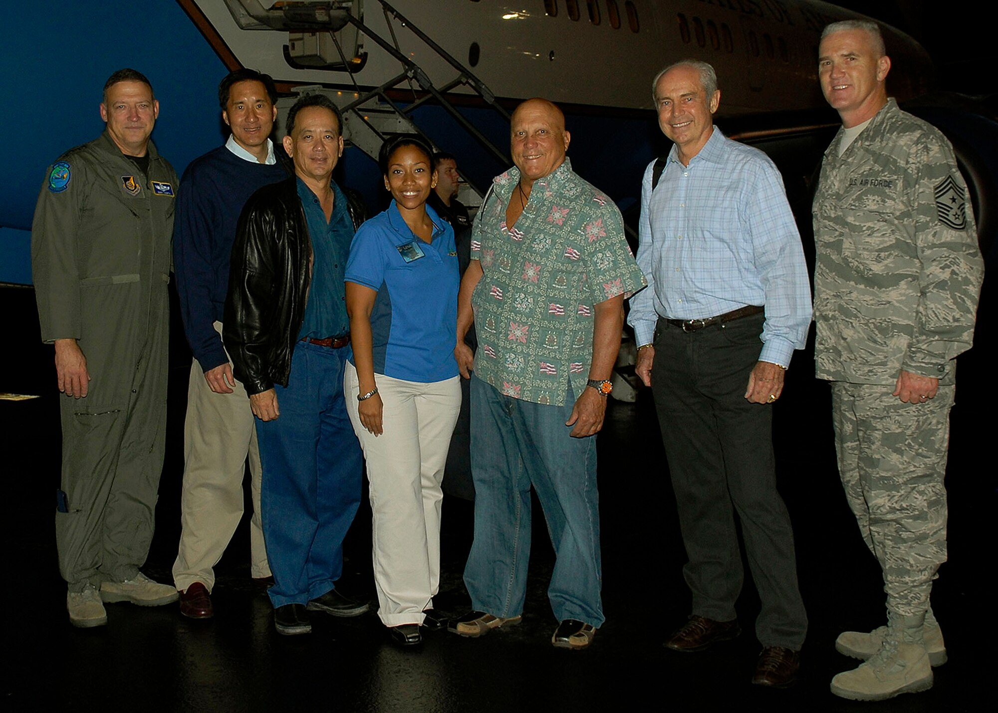 Gen. Gary North, Pacific Air Forces commander, Steven Ai, President and CES of City Mill Co. Ltd, Robin Campaniano, President and CEO of AIG Hawaii Insurance Company, Lena Lopez, PACAF chief of community relations, Anthony Guerrero, Jr., Executive Vice President for First Hawaiian Bank, Les Enderton, Executive Director of the Oahu Visitors Bureau, and Chief Master Sgt. Brooke McLean, PACAF command chief, pose for a group photo in front of a C-40 at Hickam Air Force Base, Hawaii. The group is touring Kunsan and Osan Air Bases, Republic of Korea, Nov. 21 -26 to celebrate Thanksgiving with the Airmen and for the civic leaders to get a better understanding of life for Airmen who are assigned to the ROK. (U.S. Air Force photo/Tech. Sgt. Jerome S. Tayborn)