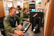 MINOT AIR FORCE BASE, N.D. - - 2nd Lt. Chuck Payne and Capt. David Cancel, both intercontinental ballistic missile deputy combat crew commanders with the 741st Missile Squadron, update mission essential information to a defensive network website here Nov. 23. Updating information such as this is paramount to the 91st Missile Wing as it continues its reinvigoration of the nuclear enterprise. (U.S. Air Force photo by Senior Airman Matthew Smith)