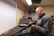 MINOT AIR FORCE BASE, N.D. -- Senior Airman Brian Carpenter, 5th Security Forces Squadron combat arms instructor, conducts a pre-embarkation inspection on an M-4 inside the Combat Arms Training and Maintenance main office Nov. 24 here. CATM is one of the most important services on any base, as they provide all Airmen with weapons training. (U.S. Air Force photo by Senior Airman Matthew Smith)