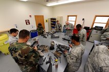 MINOT AIR FORCE BASE, N.D. -- Airman clean their weapons after firing the final portion of Air Force Qualification Course on a Combat Arms Training and Maintenance range Nov. 24 here. CATM is one of the most important services on any base, as they provide all Airmen with weapons training. (U.S. Air Force photo by Senior Airman Matthew Smith)