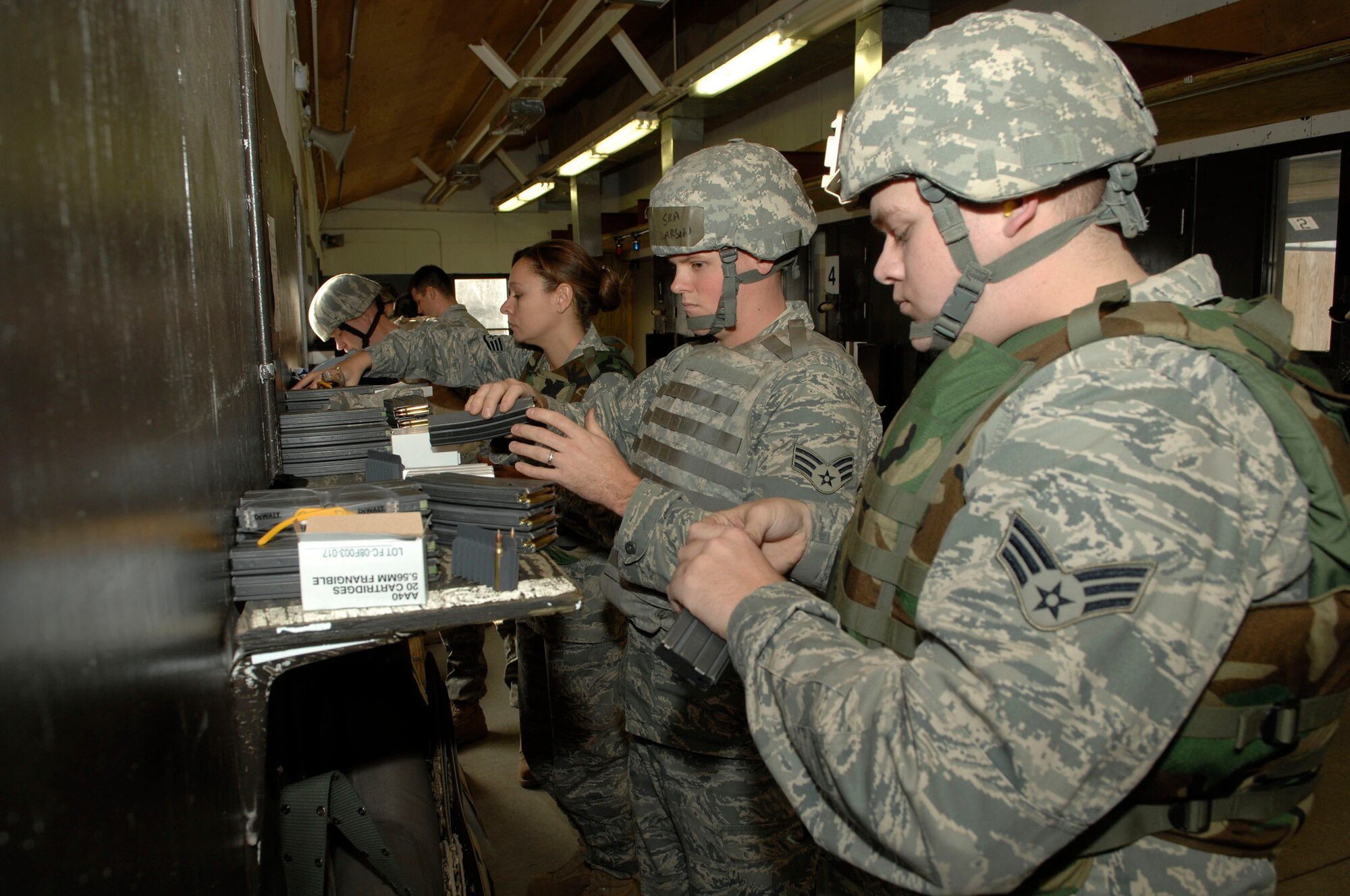 MINOT AIR FORCE BASE, N.D. -- Airmen load magazines with rounds before the final portion of Air Force Qualification Course on a Combat Arms Training and Maintenance range Nov. 24 here. CATM is one of the most important services on any base, as they provide all Airmen with weapons training. (U.S. Air Force photo by Senior Airman Matthew Smith)