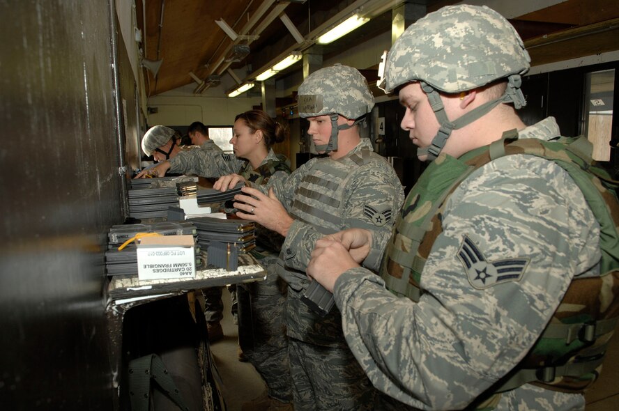 MINOT AIR FORCE BASE, N.D. -- Airmen load magazines with rounds before the final portion of Air Force Qualification Course on a Combat Arms Training and Maintenance range Nov. 24 here. CATM is one of the most important services on any base, as they provide all Airmen with weapons training. (U.S. Air Force photo by Senior Airman Matthew Smith)